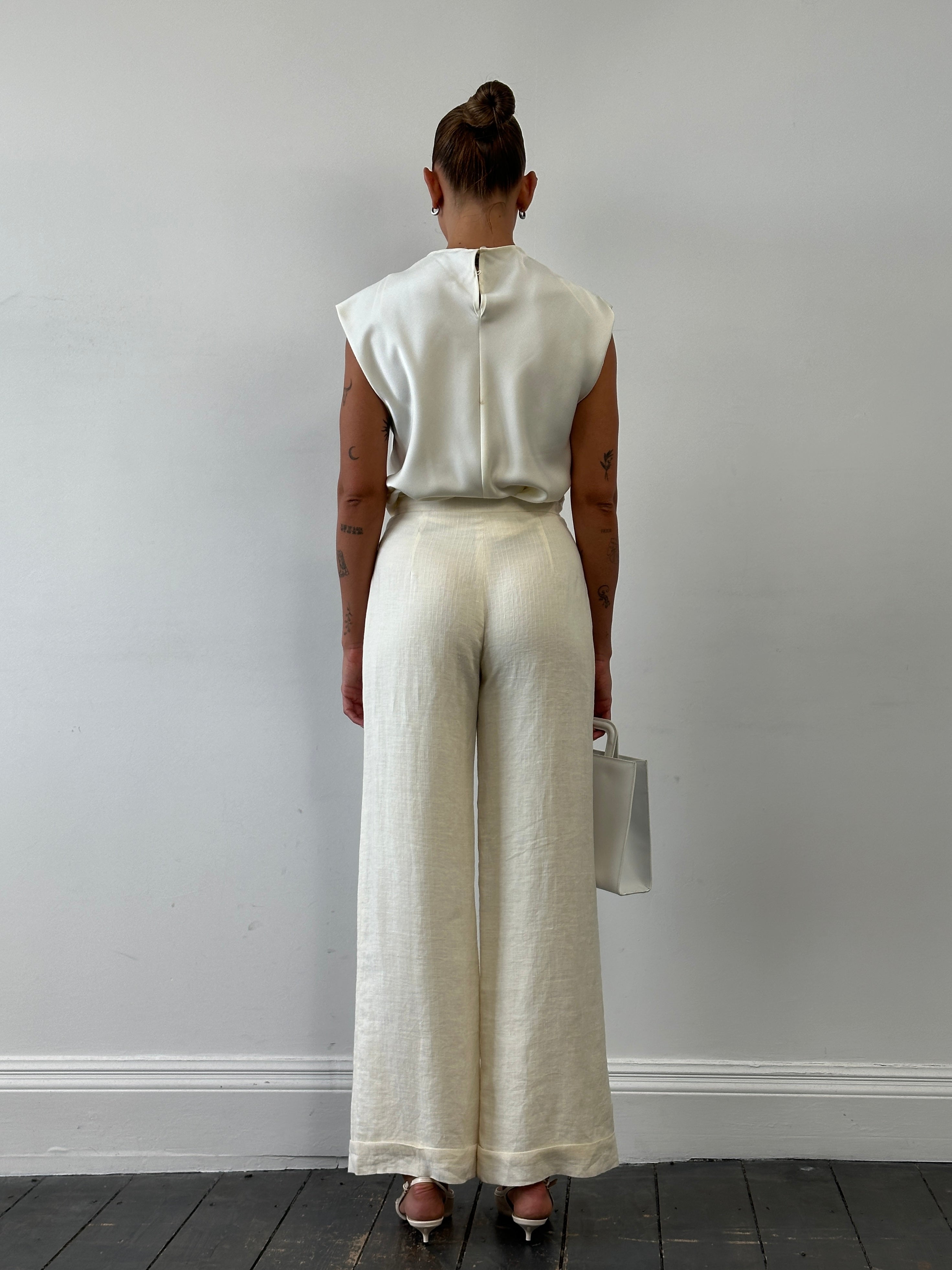 Vintage high-waisted wide-leg tailored trousers in size 26, showcasing classic retro style and structured fit.