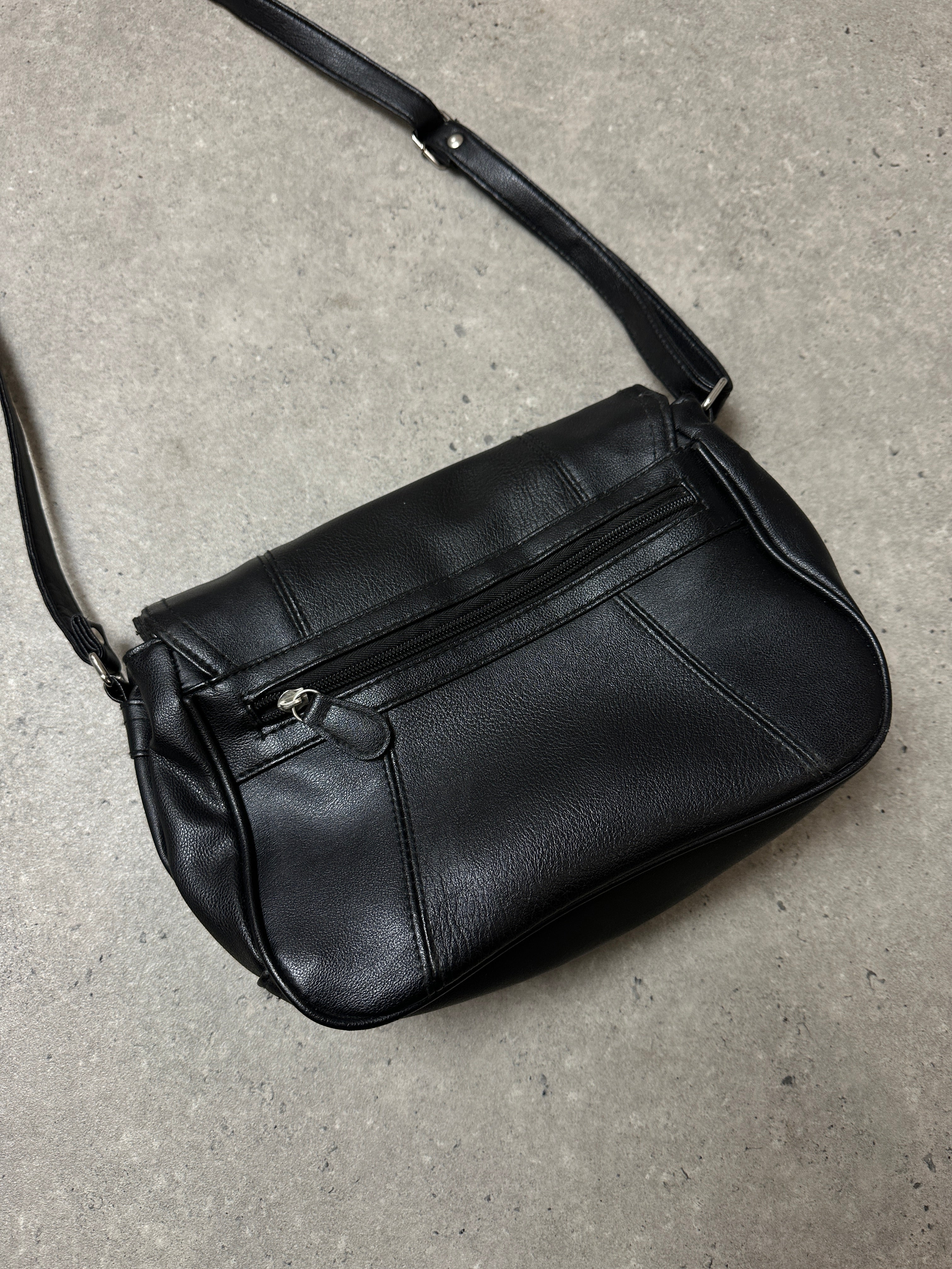 Vintage faux leather crossbody bag with adjustable strap and metal hardware, stylish and compact for everyday use.