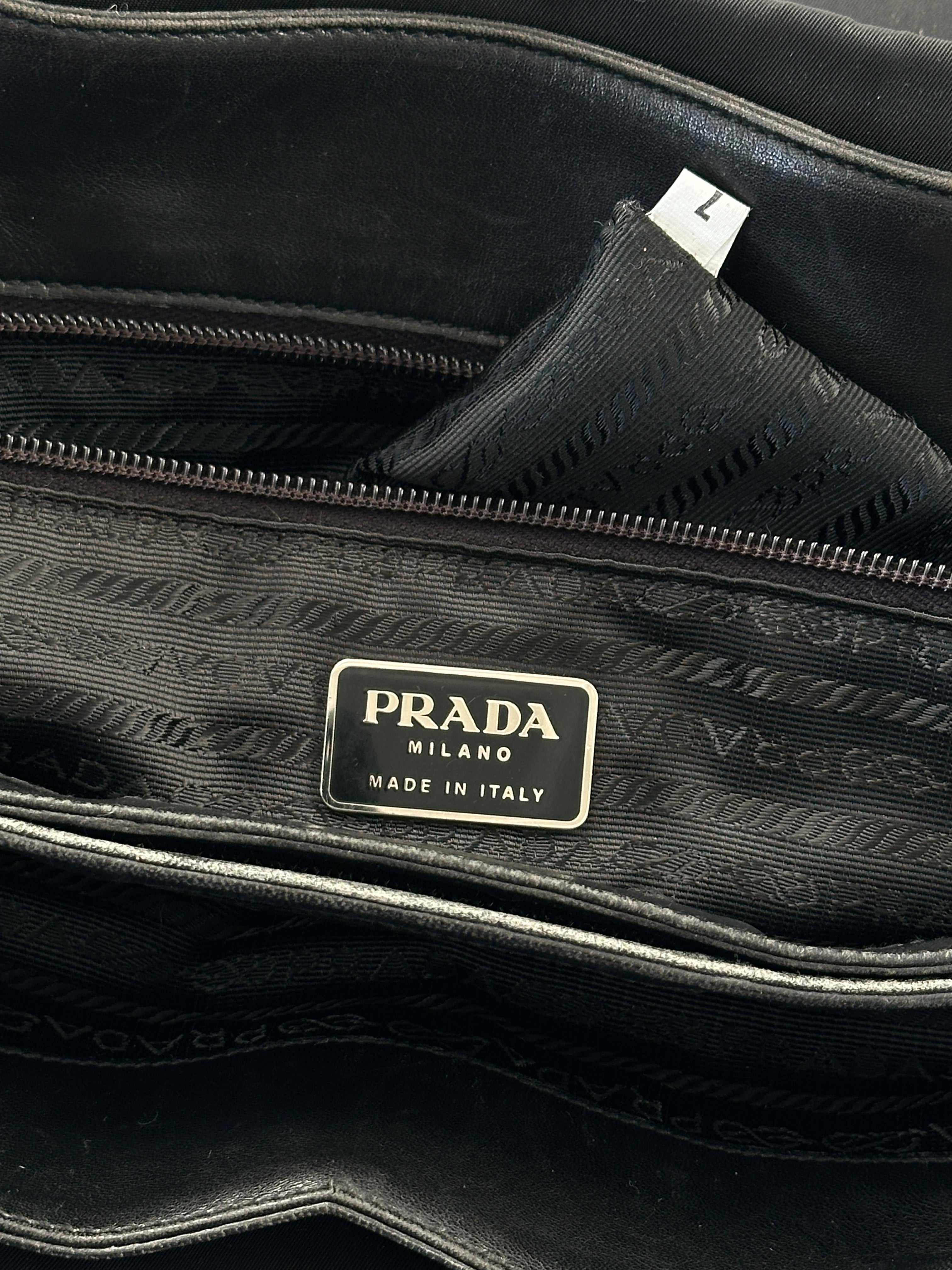 Prada nylon leather tote bag with sleek design, featuring sturdy handles and spacious interior for everyday use.