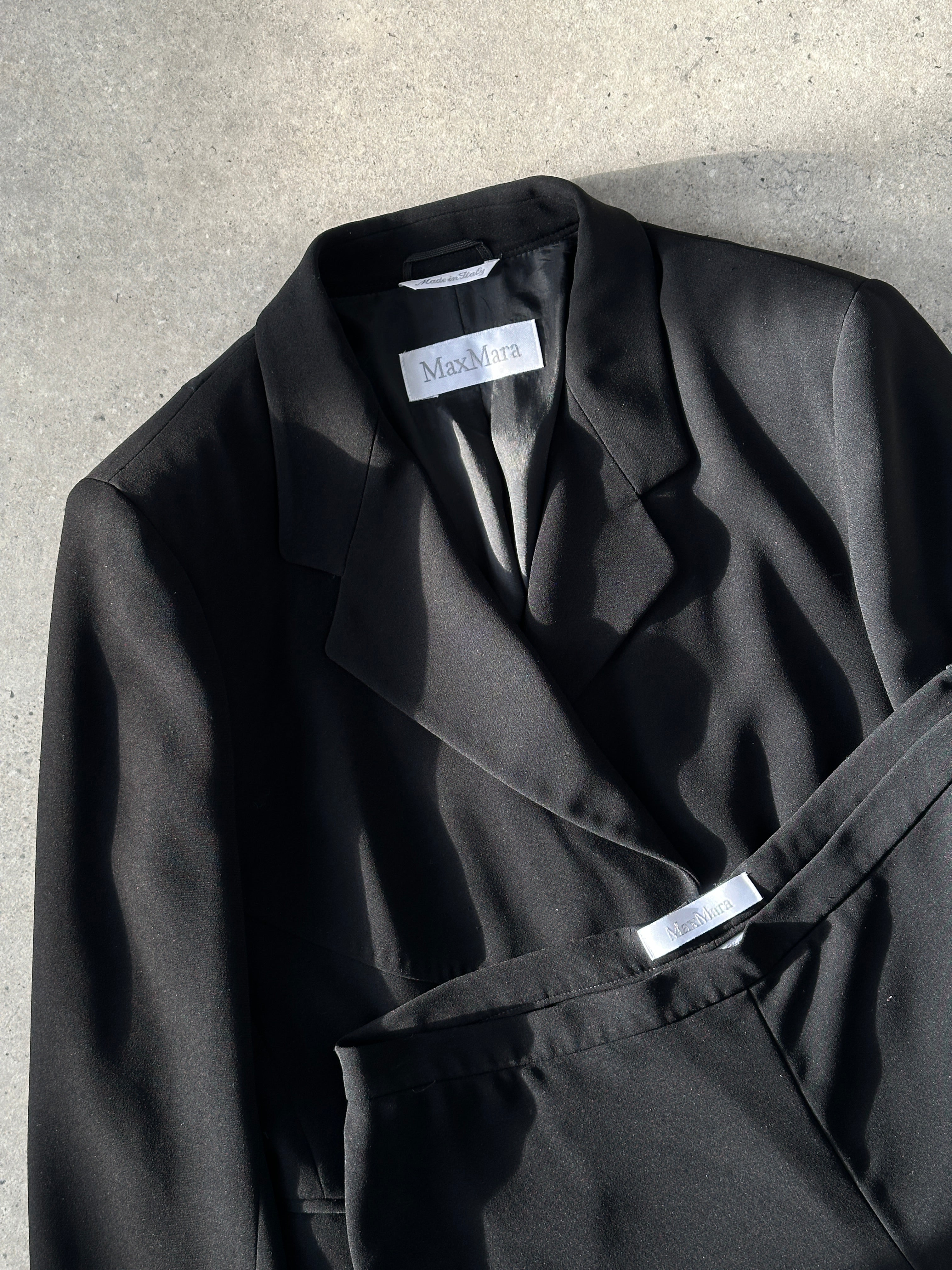 Max Mara minimal single-breasted jumpsuit in sleek fabric, featuring a classic design and tailored fit.