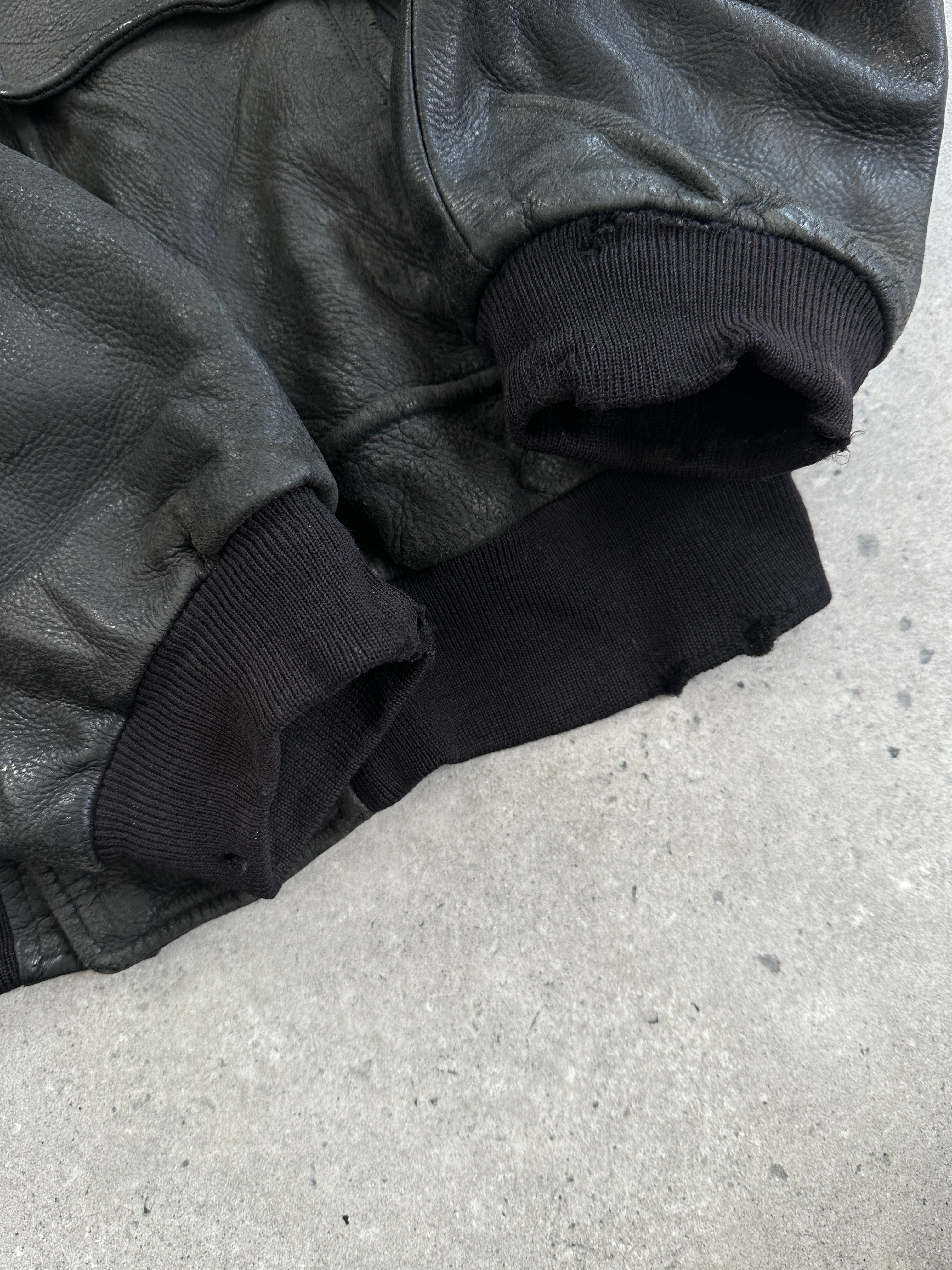 Vintage Italian aged leather bomber jacket in size XL with classic design and distressed leather details.