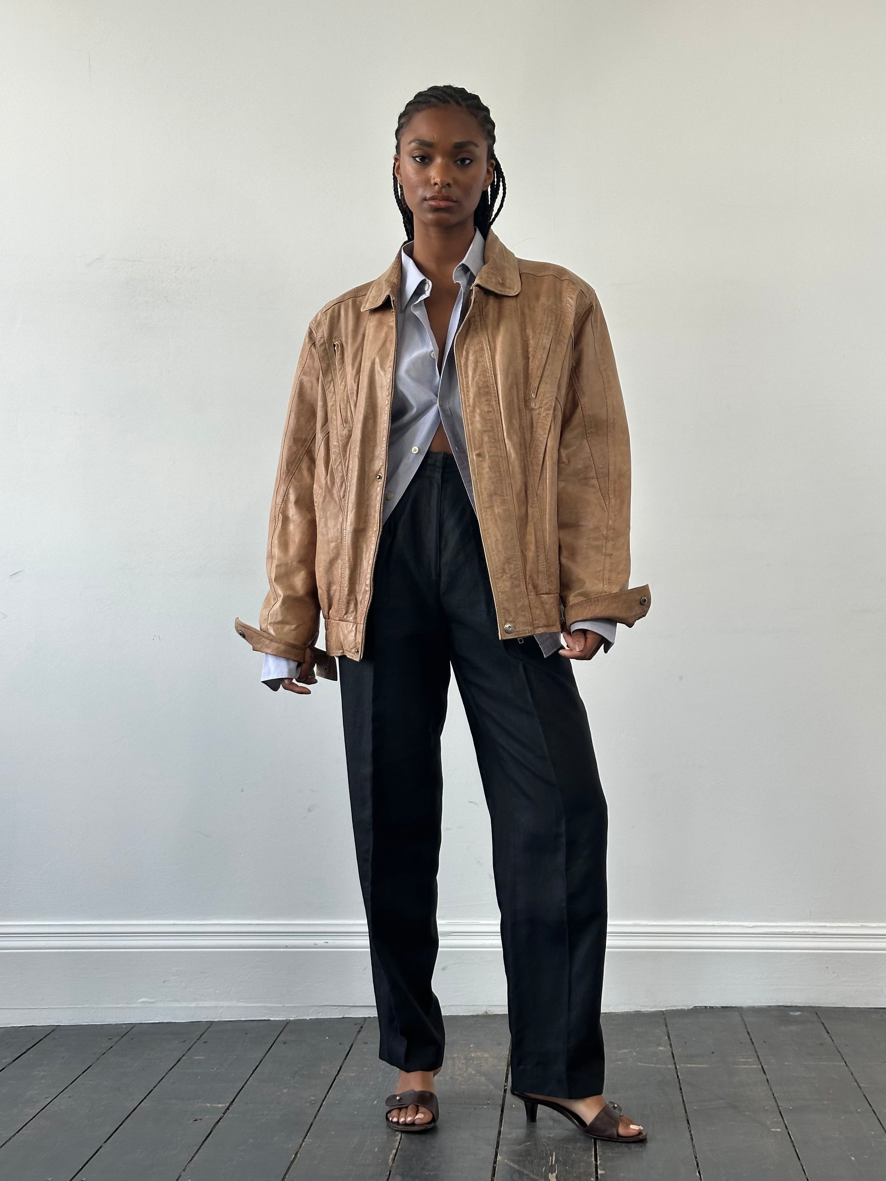 Vintage 1990s leather bomber jacket in size large, featuring classic design and aged leather texture.