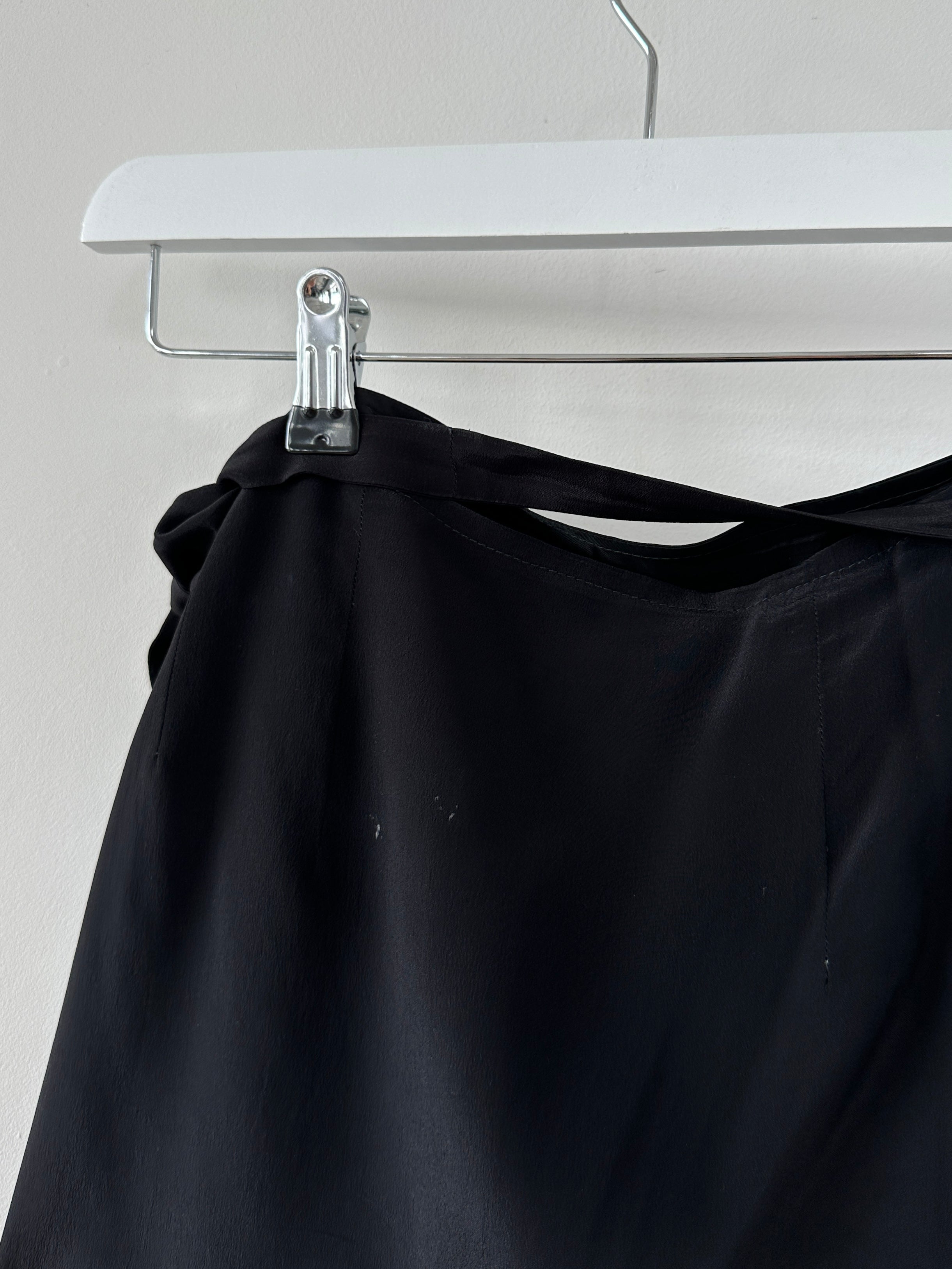 Vintage mini wrap skirt in a classic style, featuring a fitted waistband and flowing fabric, shown from the front.