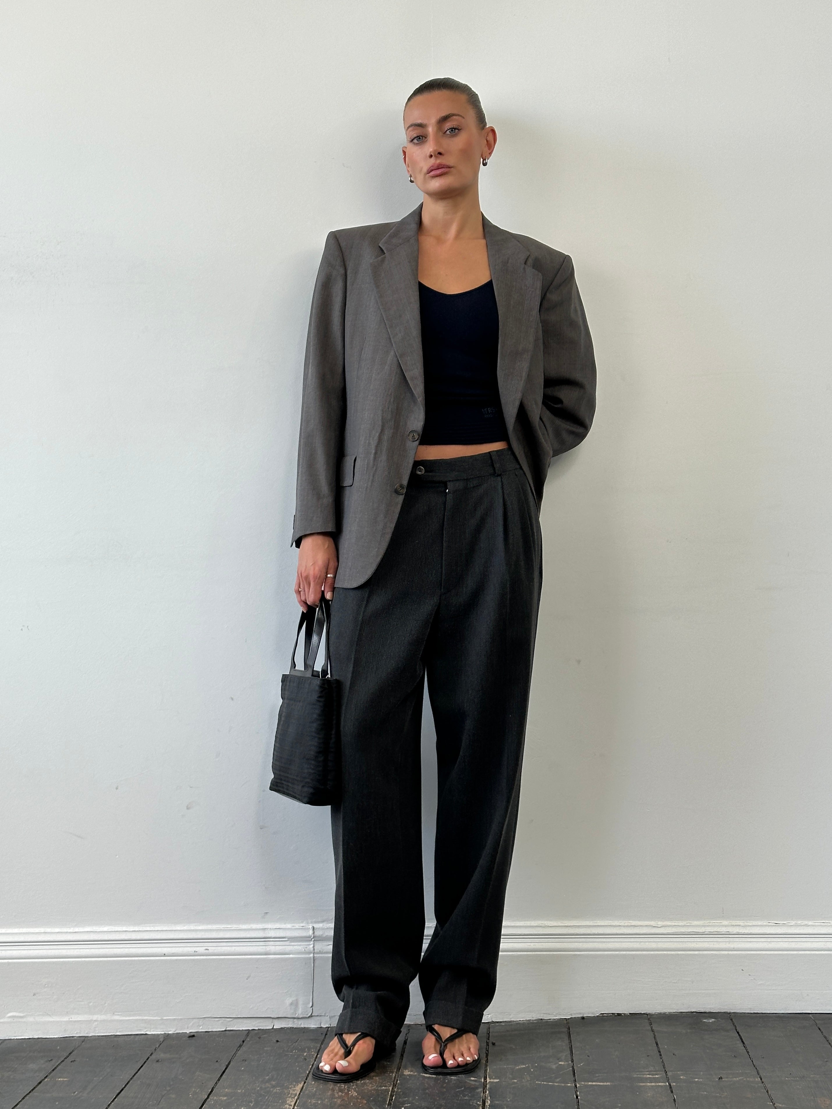 Vintage high waisted woven pleated tailored trousers in size W30, featuring a classic design and textured fabric.