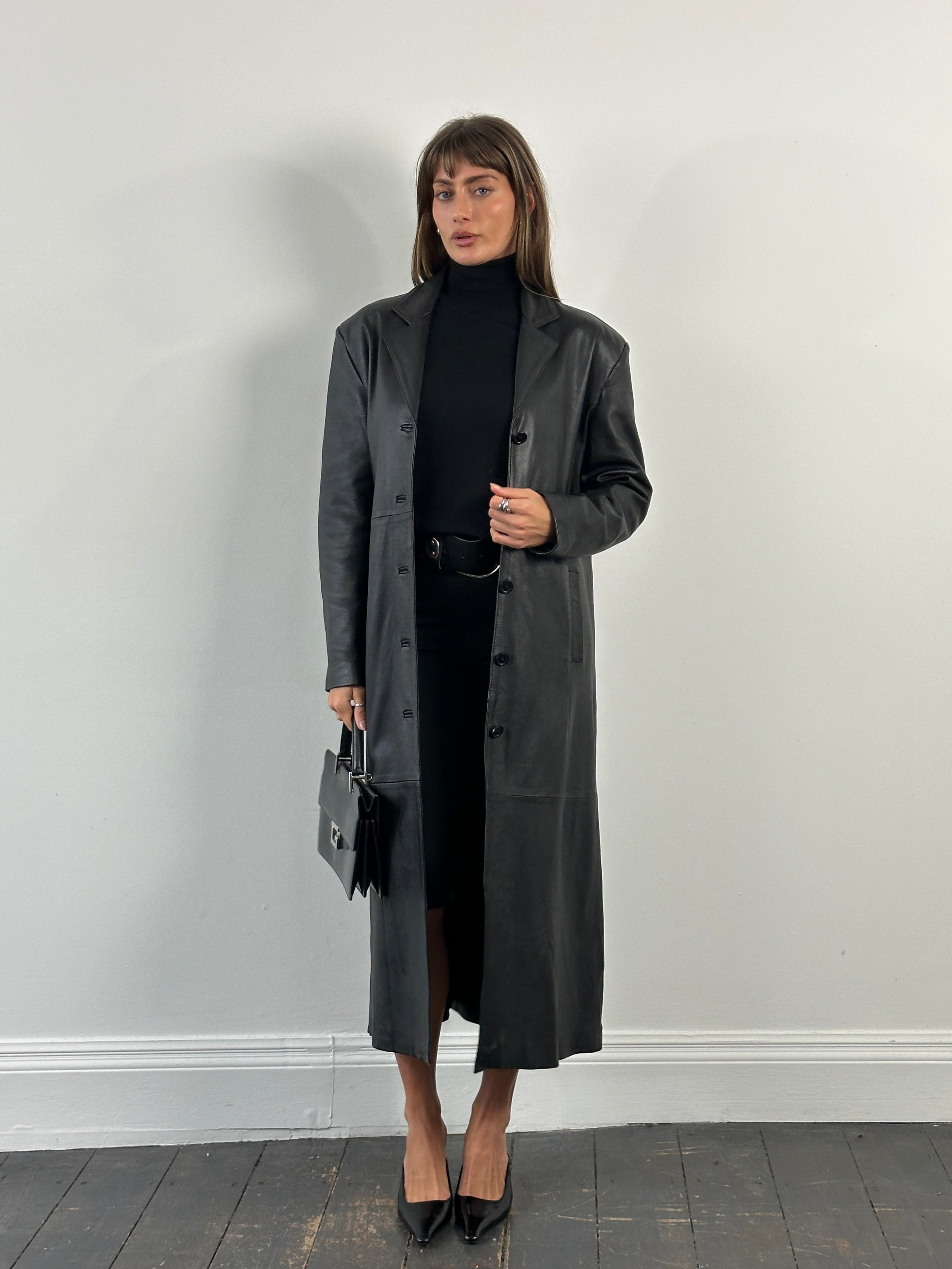 Vintage 1990s floor-length leather trench coat, size large, with classic design and detailed leather texture, vintage style.