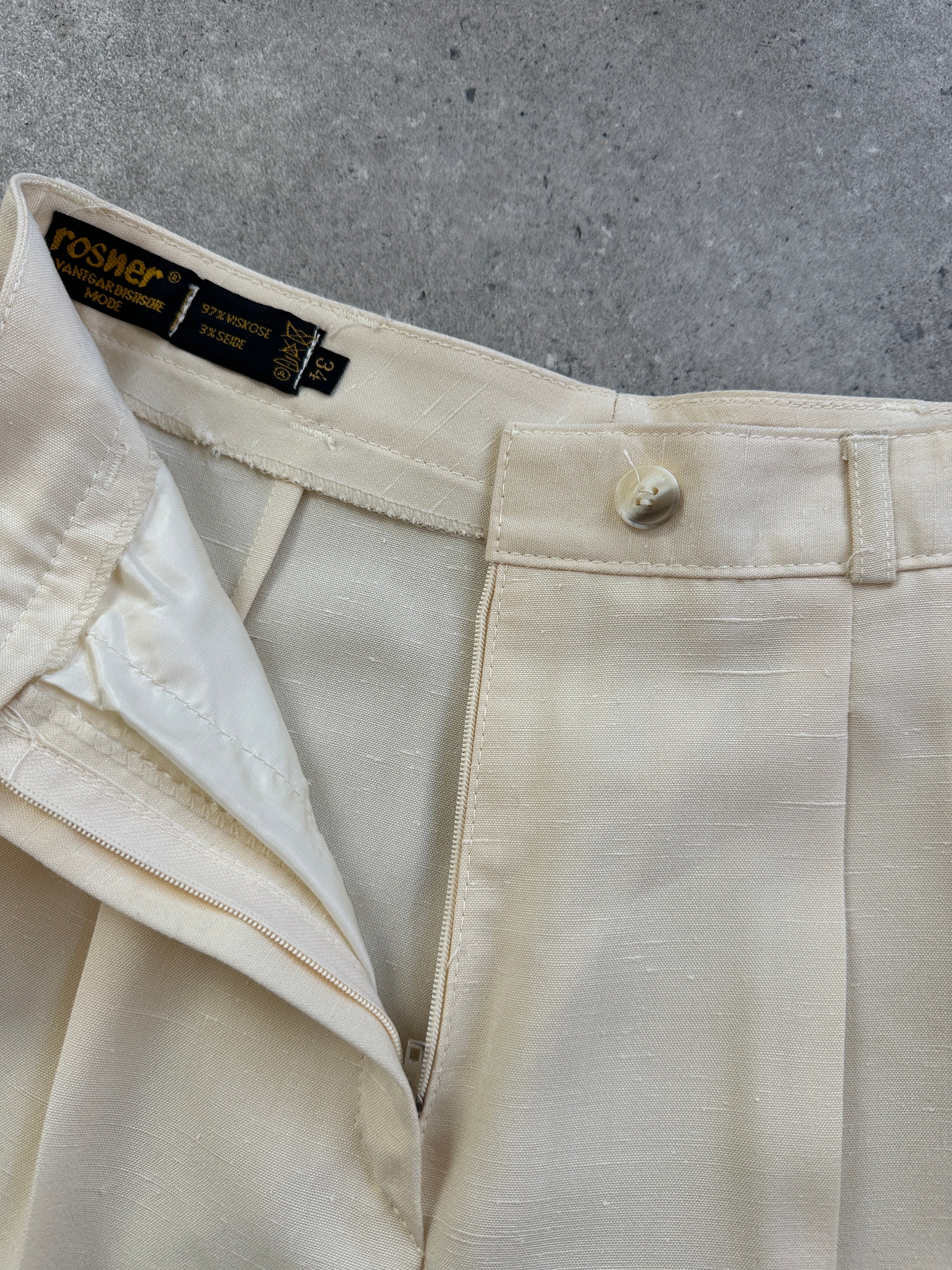 Vintage 1990s high-waisted straight-leg tailored trousers in classic dark fabric, displayed on a neutral background.