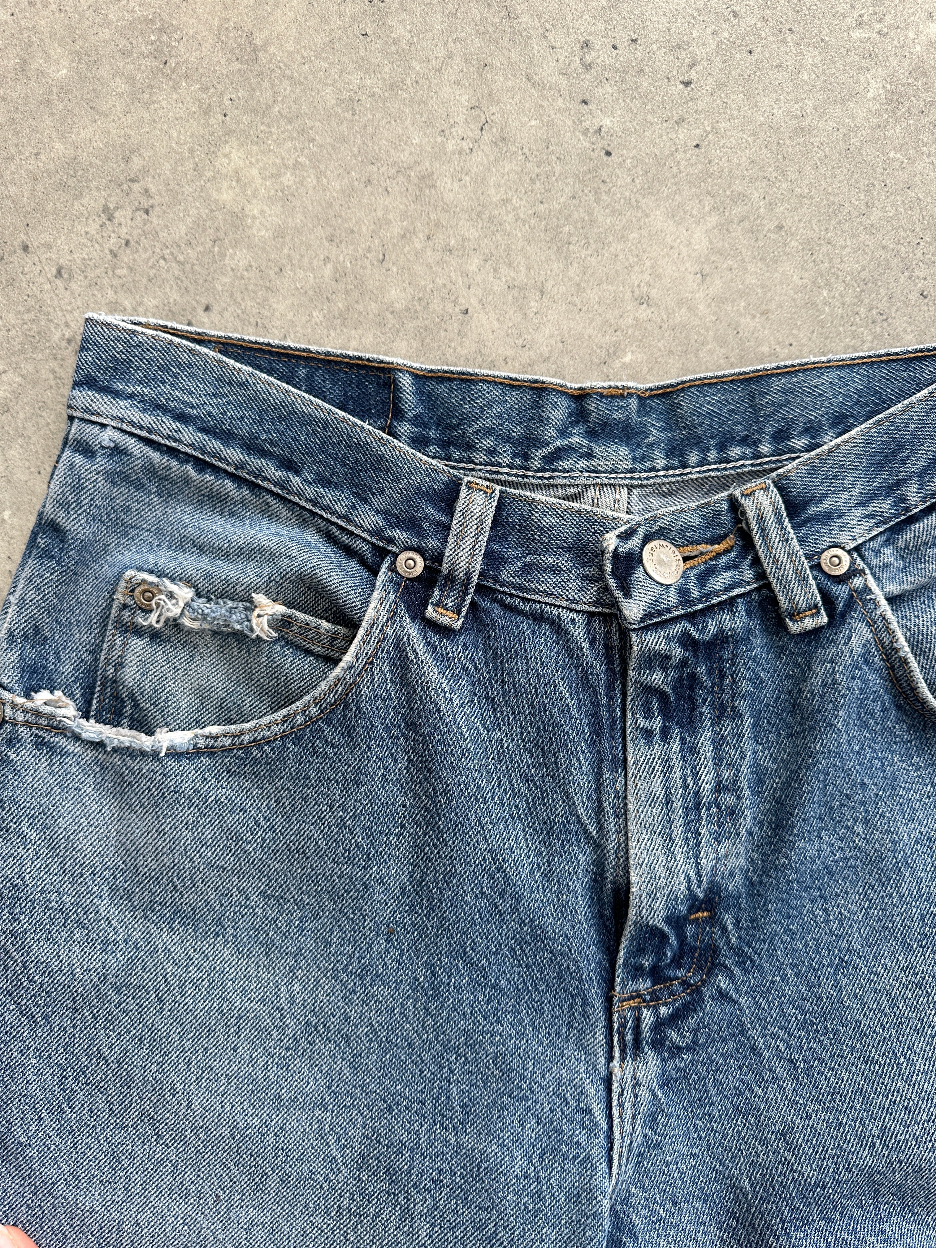 Wrangler mid wash straight leg high waisted denim jeans, size W28, showing classic fit and stitching details.