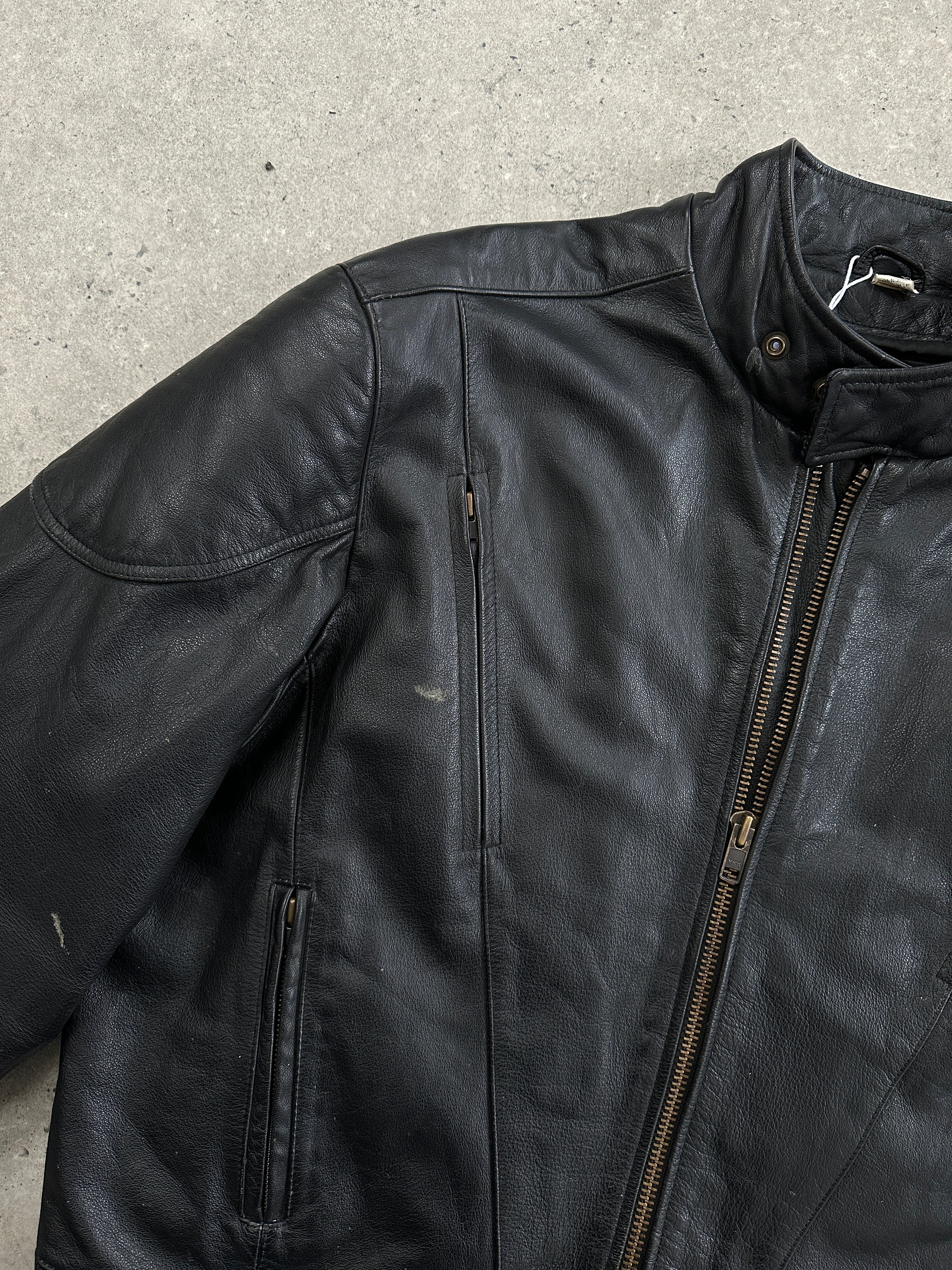 Vintage leather motorcycle jacket in size XL featuring classic design, durable material, and detailed stitching.