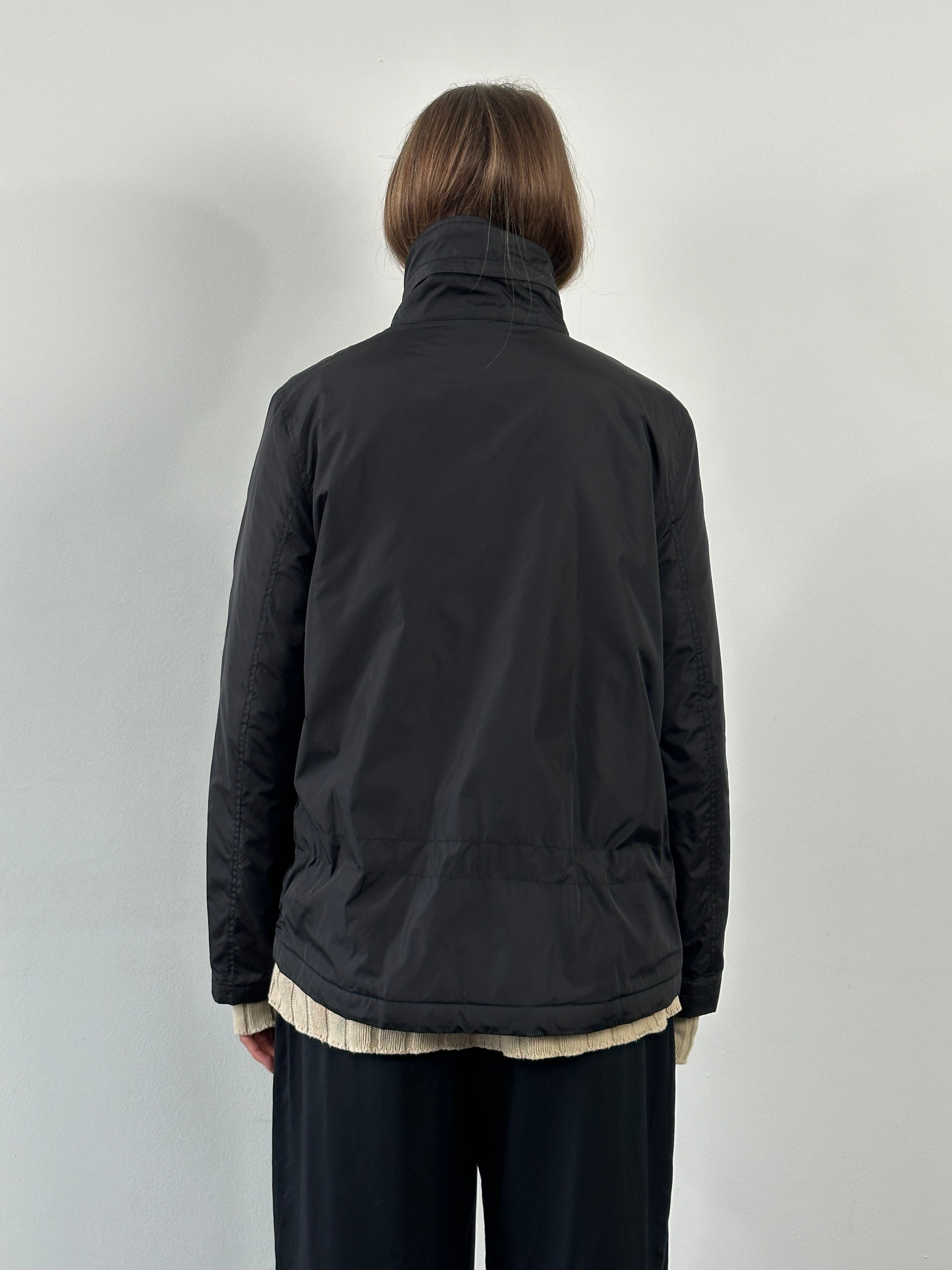 Burberry London 2000s nylon high neck jacket in size L, showcasing a sleek black design with a high collar and lightweight material.
