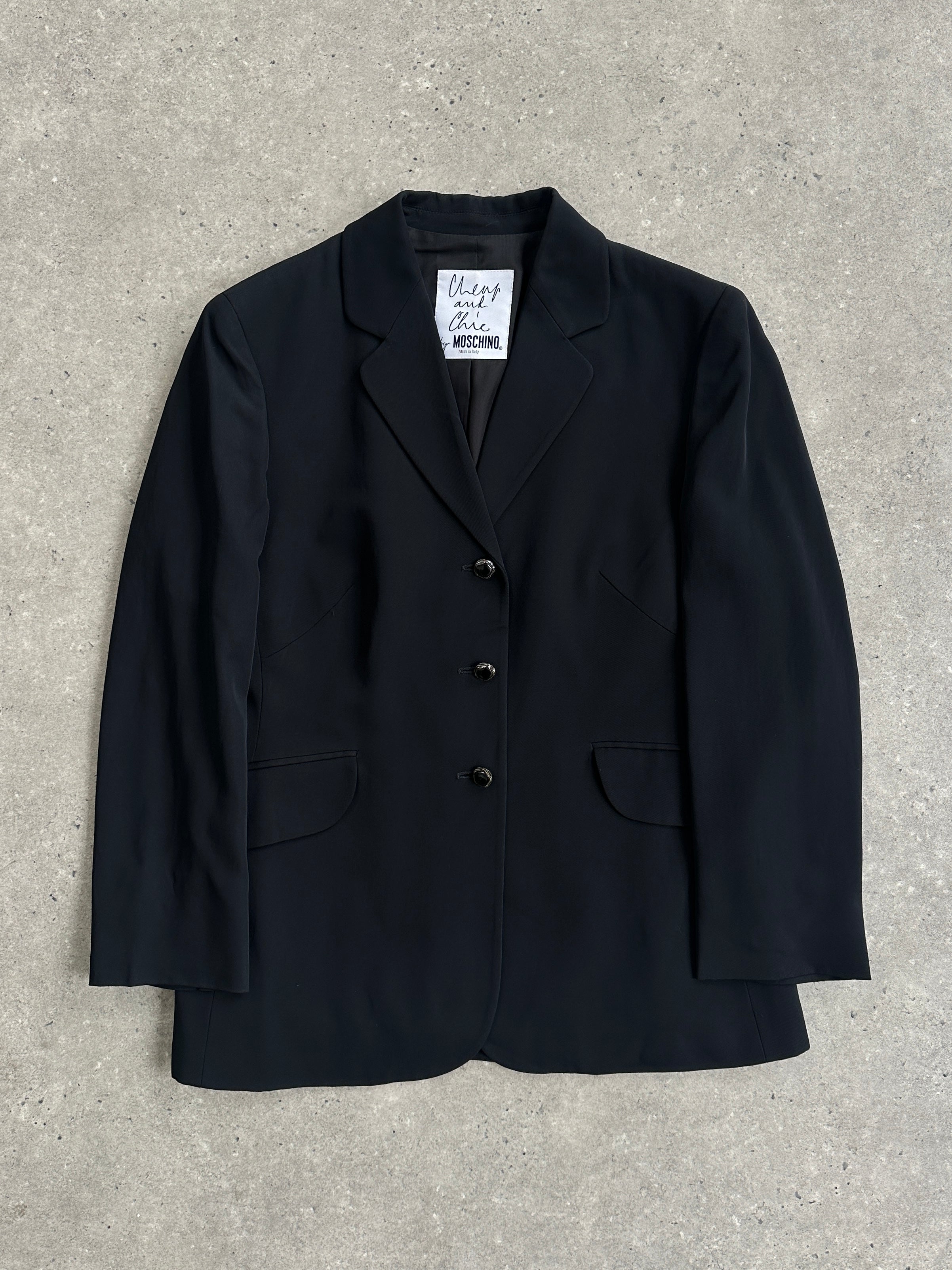 Moschino Cheap & Chic 90s single-breasted blazer in black, tailored fit with classic lapel, styled on a mannequin.