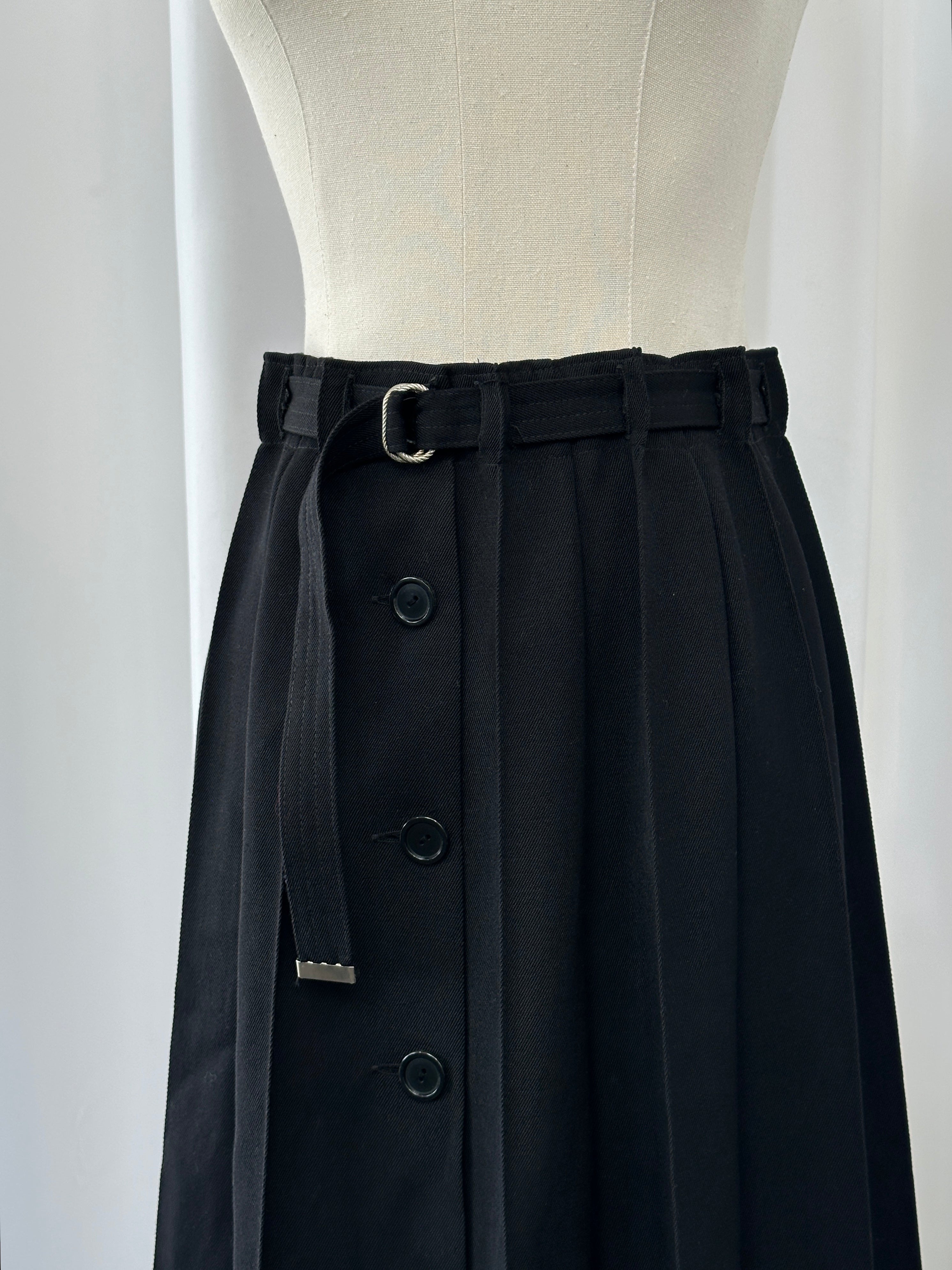 Vintage 1990s wool pleated midi skirt in neutral tones, styled with a high waist and classic pleats, size W26.