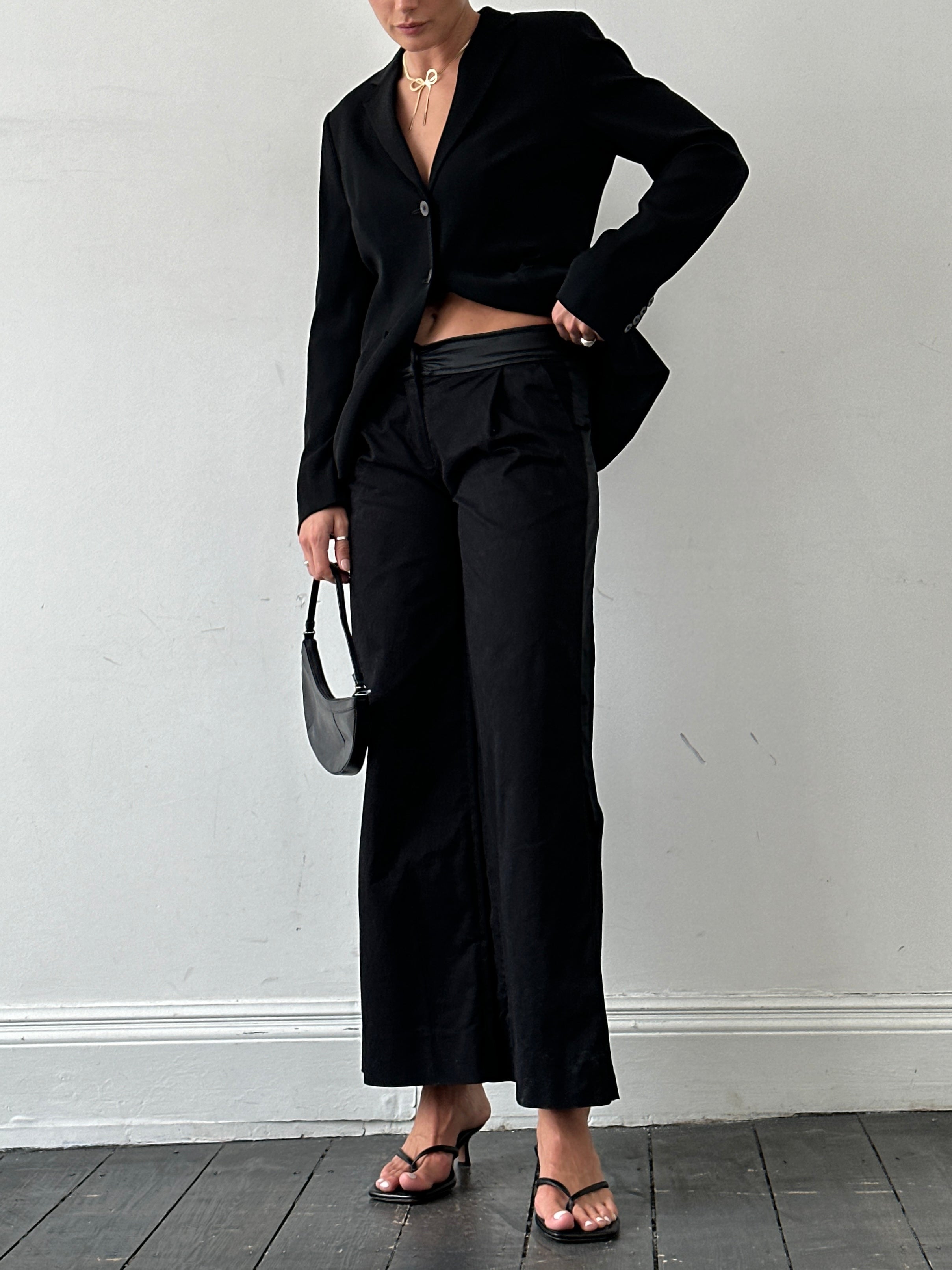 Gianfranco Ferre wide-leg low-waist tuxedo trousers in black, showing tailored fit and crisp fabric details.
