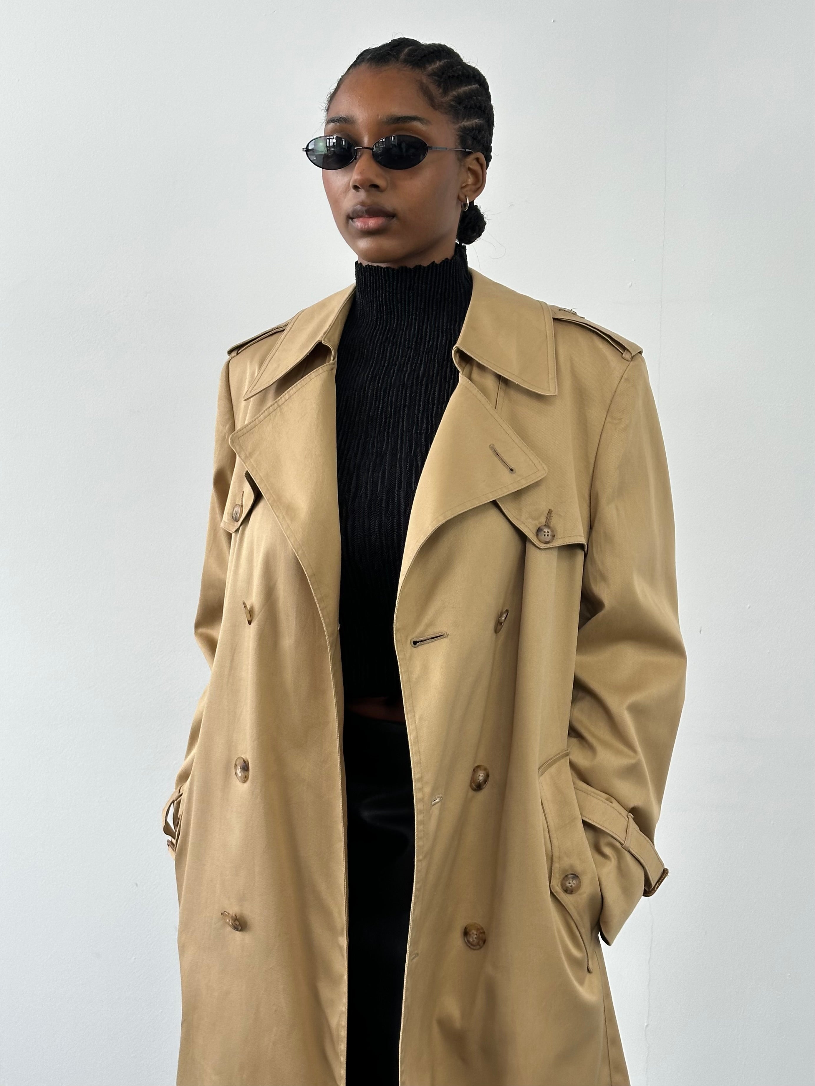 Christian Dior Paris 1980s cotton double-breasted trench coat in beige, shown on a hanger with classic tailored details.