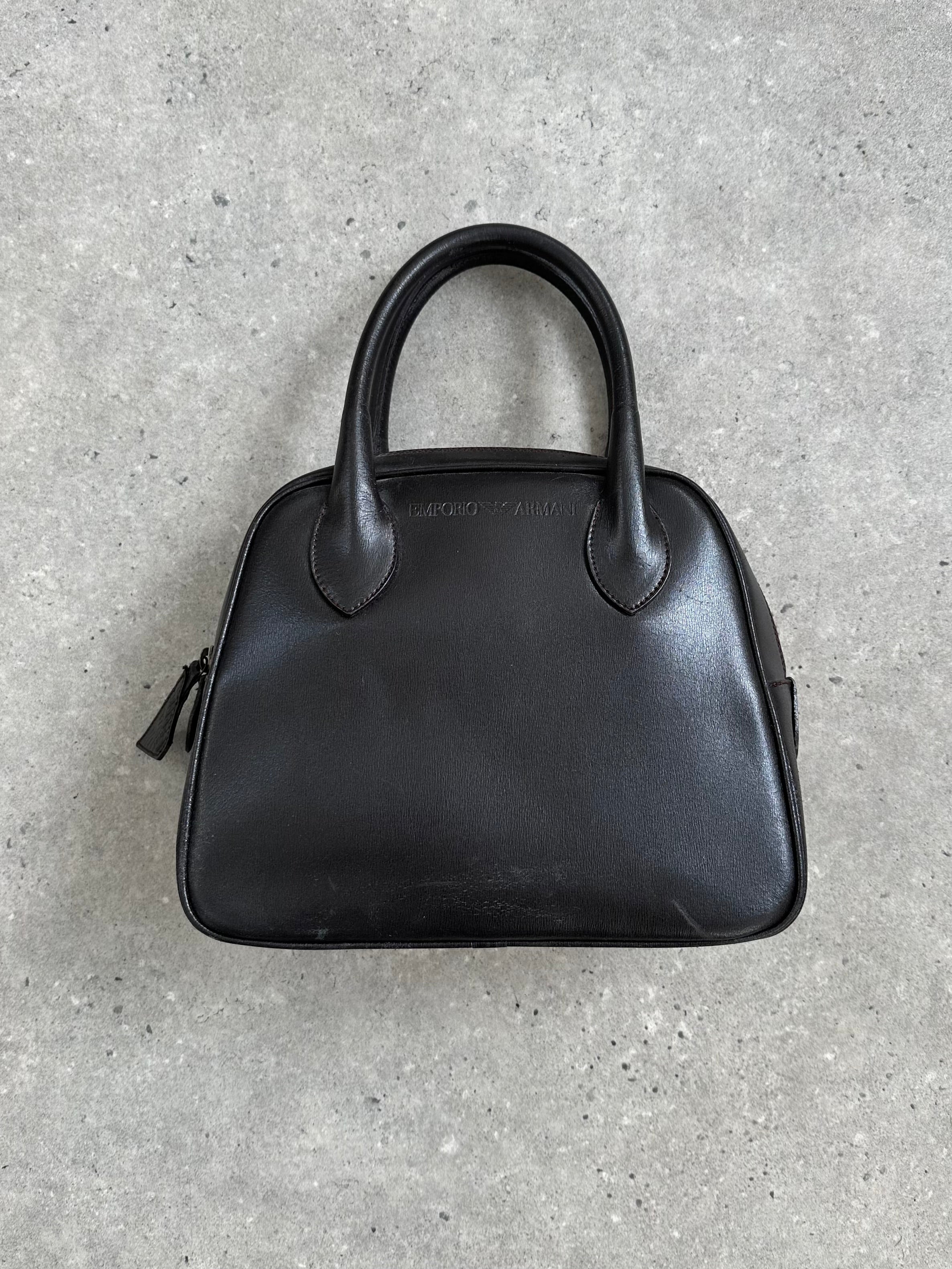 Emporio Armani 2000s leather handbag with sleek design and subtle branding, featuring a structured silhouette and top handle.