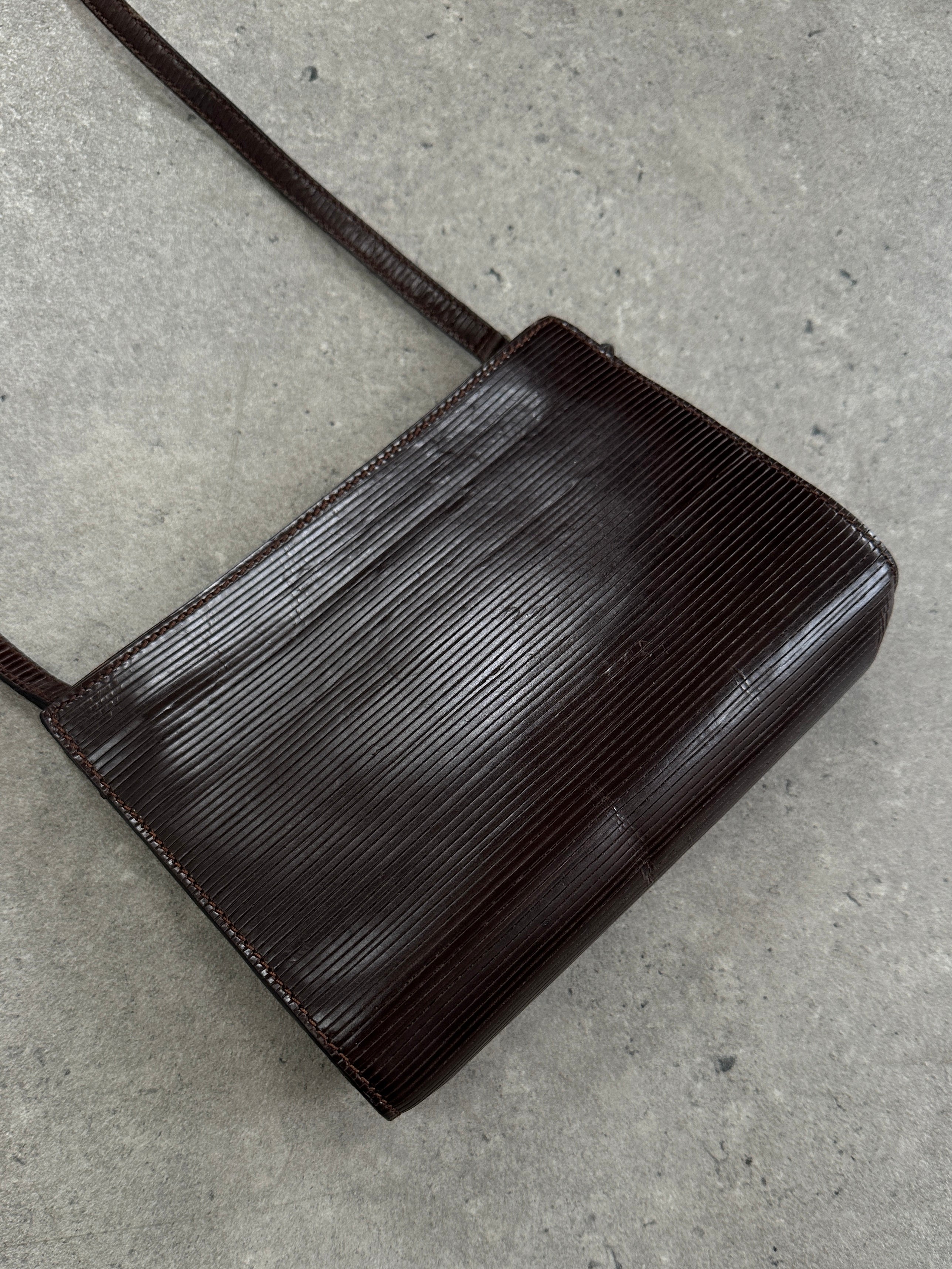 Giorgio Armani Le Collezioni 1990s leather crossbody bag with adjustable strap and classic design, in a neutral color.