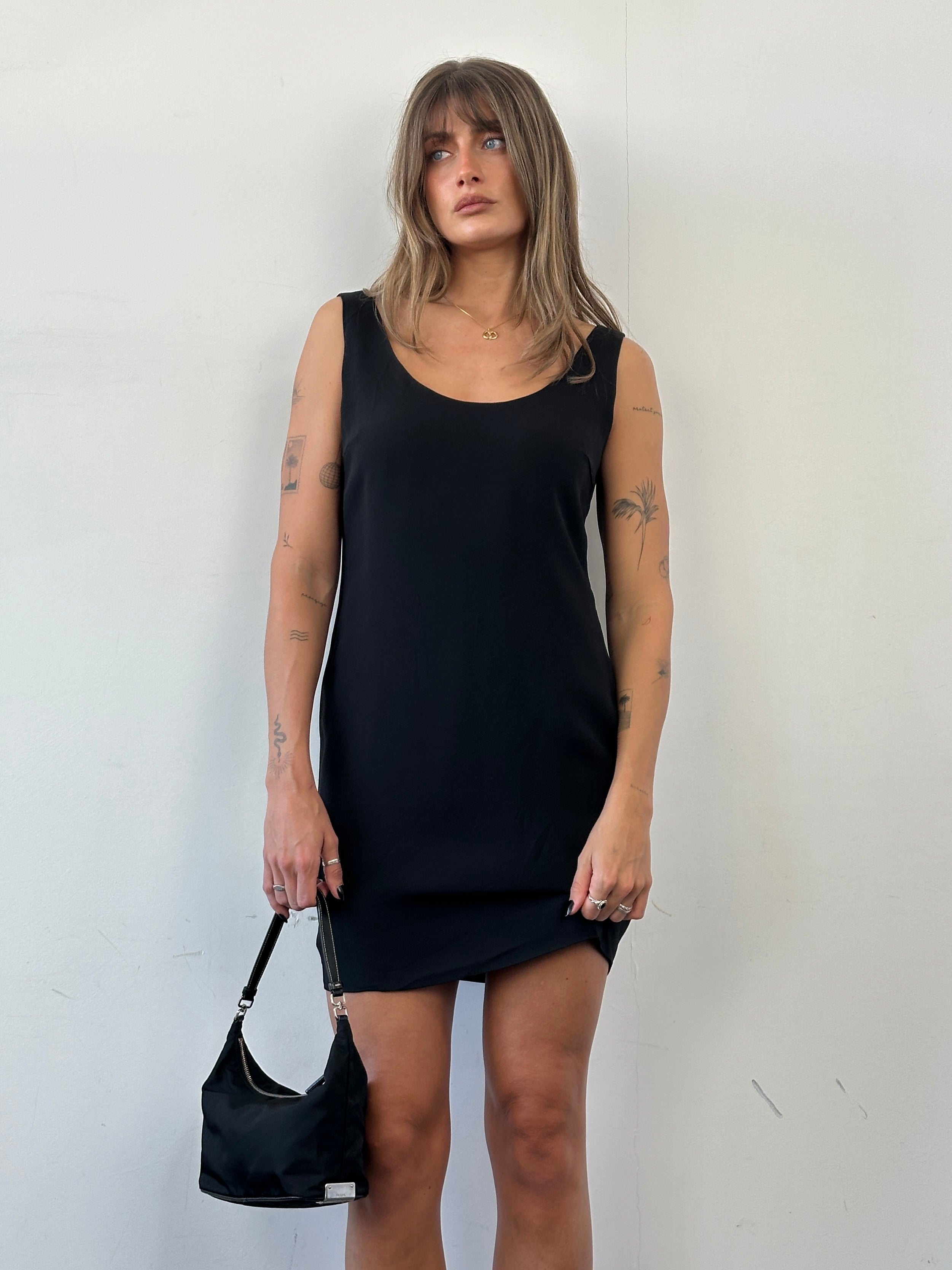 Moschino Couture fitted mini dress in black with bold logo print, short sleeves, and stylish design for contemporary fashion.