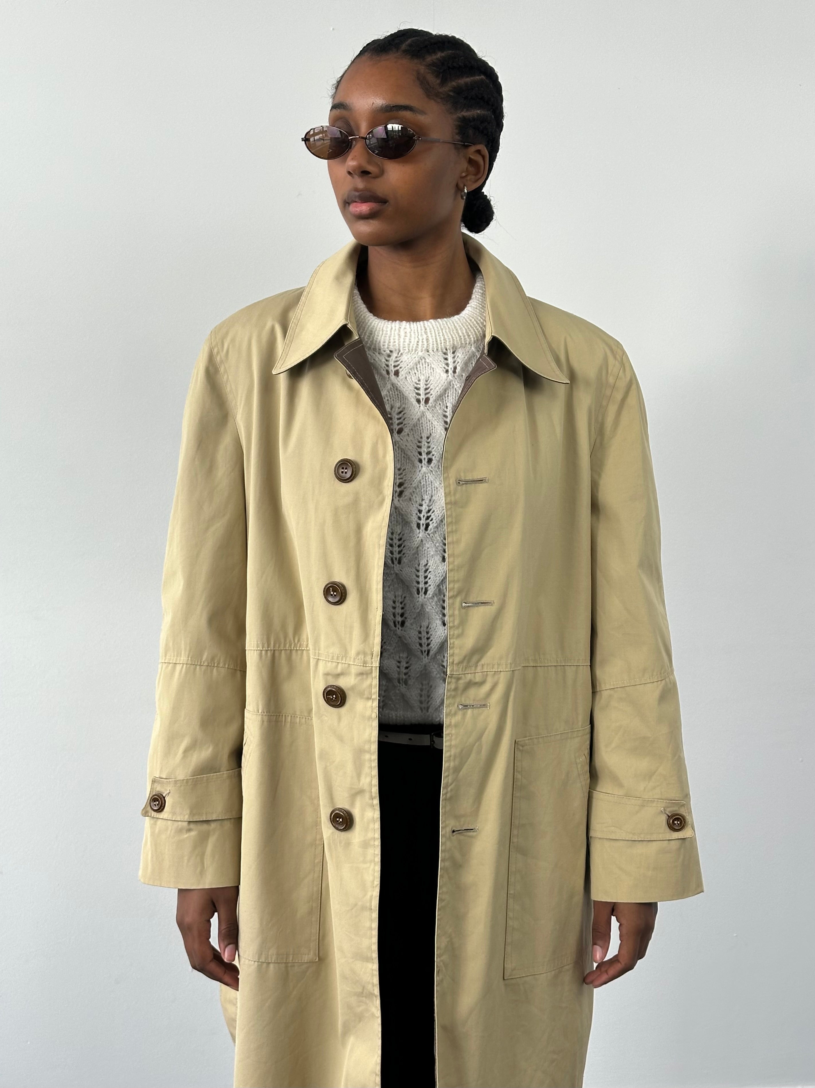 Christian Dior Paris 1980s cotton belted trench coat, front view showing classic design and beige color.