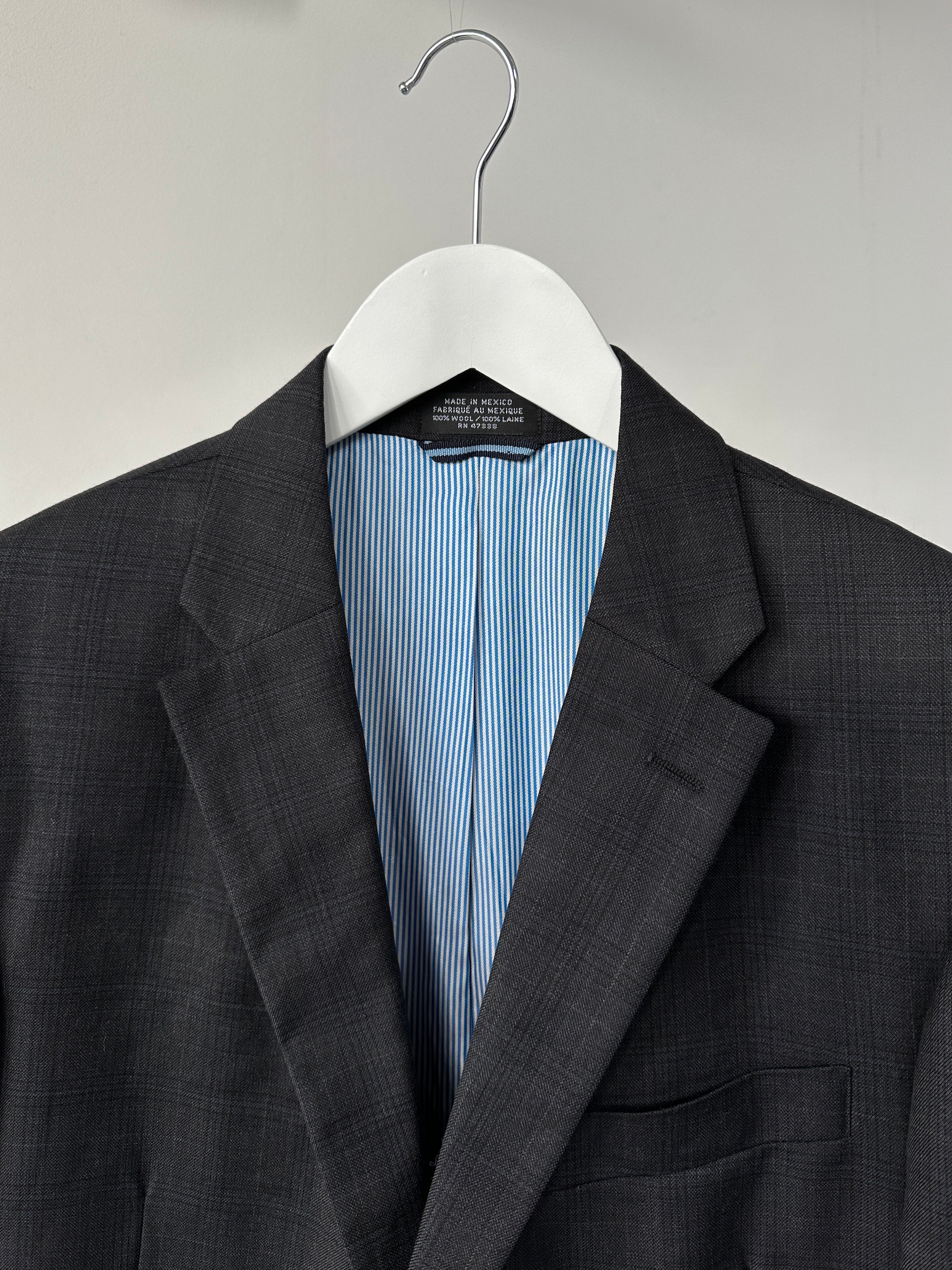 Tommy Hilfiger wool check blazer in navy and red, tailored fit with notched lapel and front buttons, displayed on a hanger.
