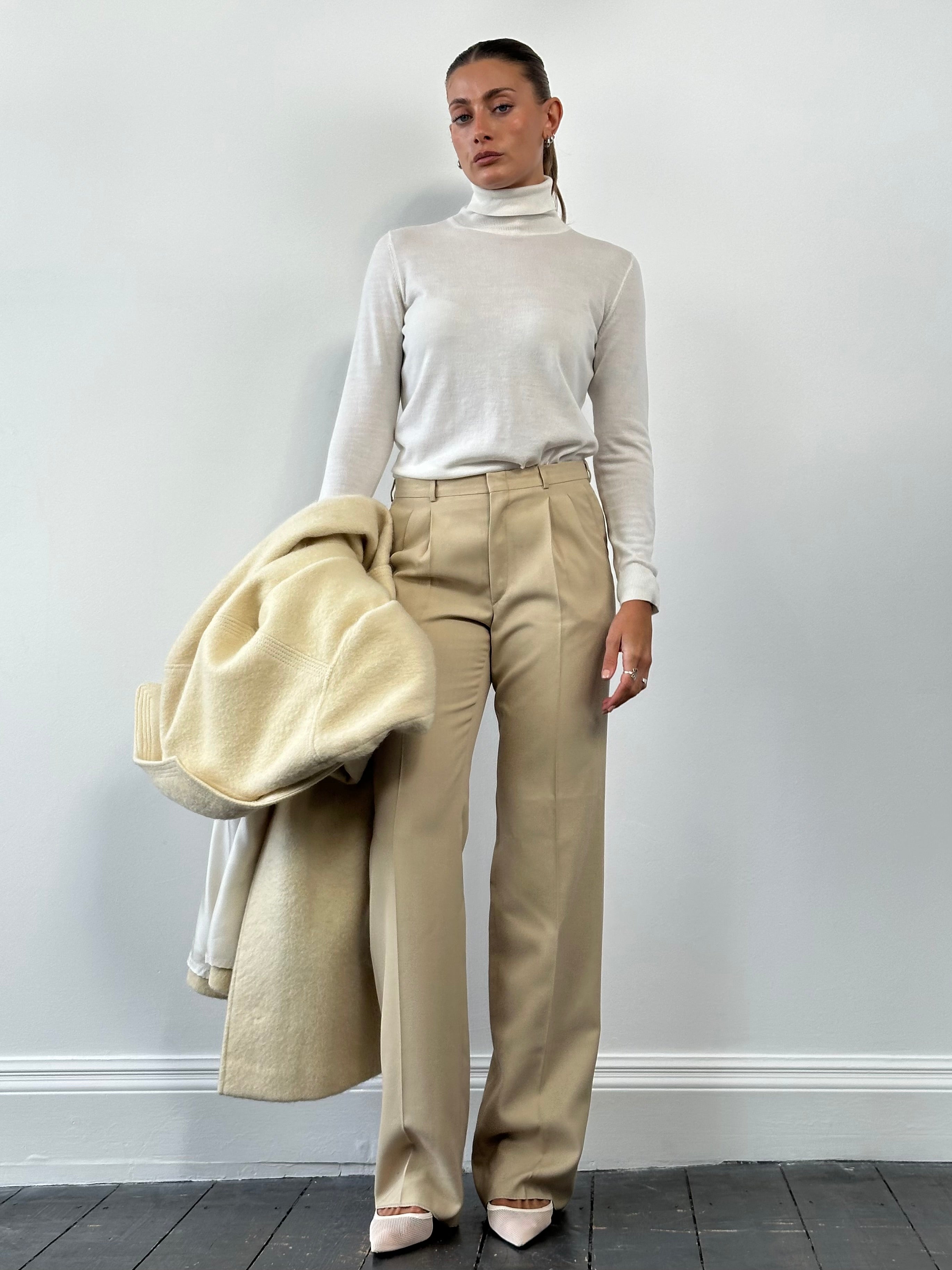 Vintage mid rise straight leg tailored trousers in a neutral fabric, displayed on a hanger with a classic fit and clean design.