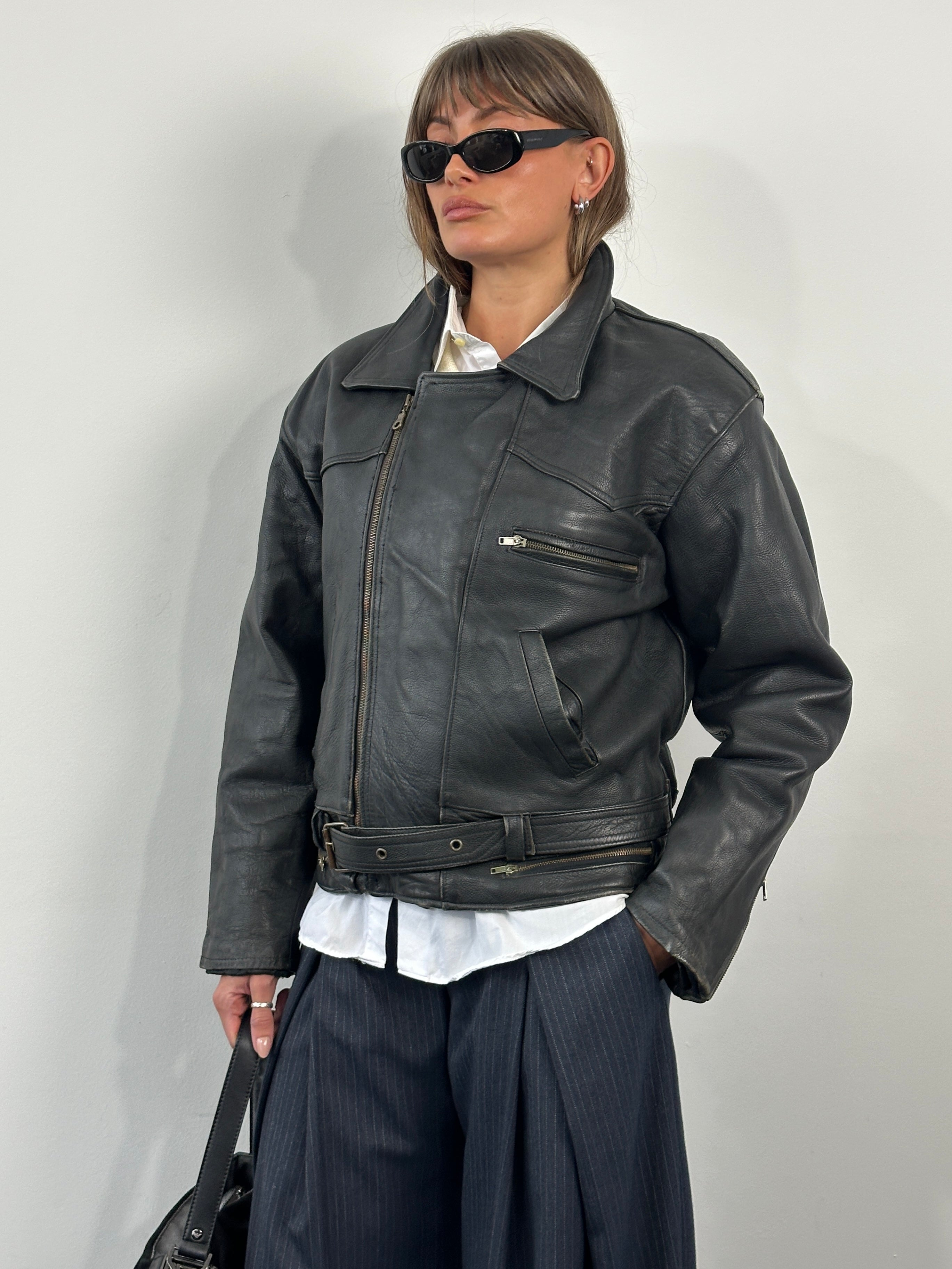 Vintage 1990s leather biker jacket in size M/L, showcasing classic distressed leather and vintage style details.