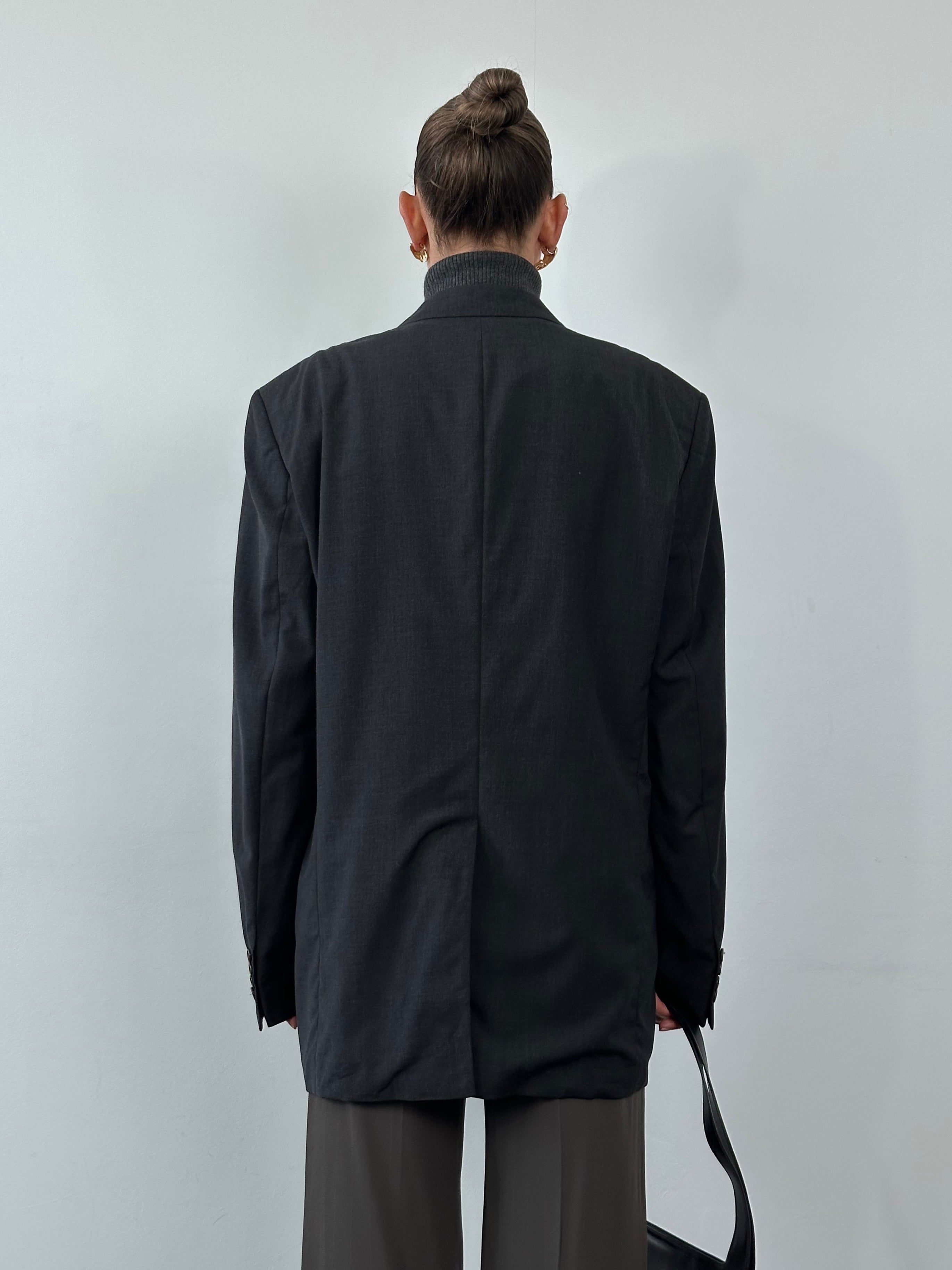 Hugo Boss virgin wool single-breasted blazer in size 42R/XL, tailored fit with notch lapels, displayed on a hanger.