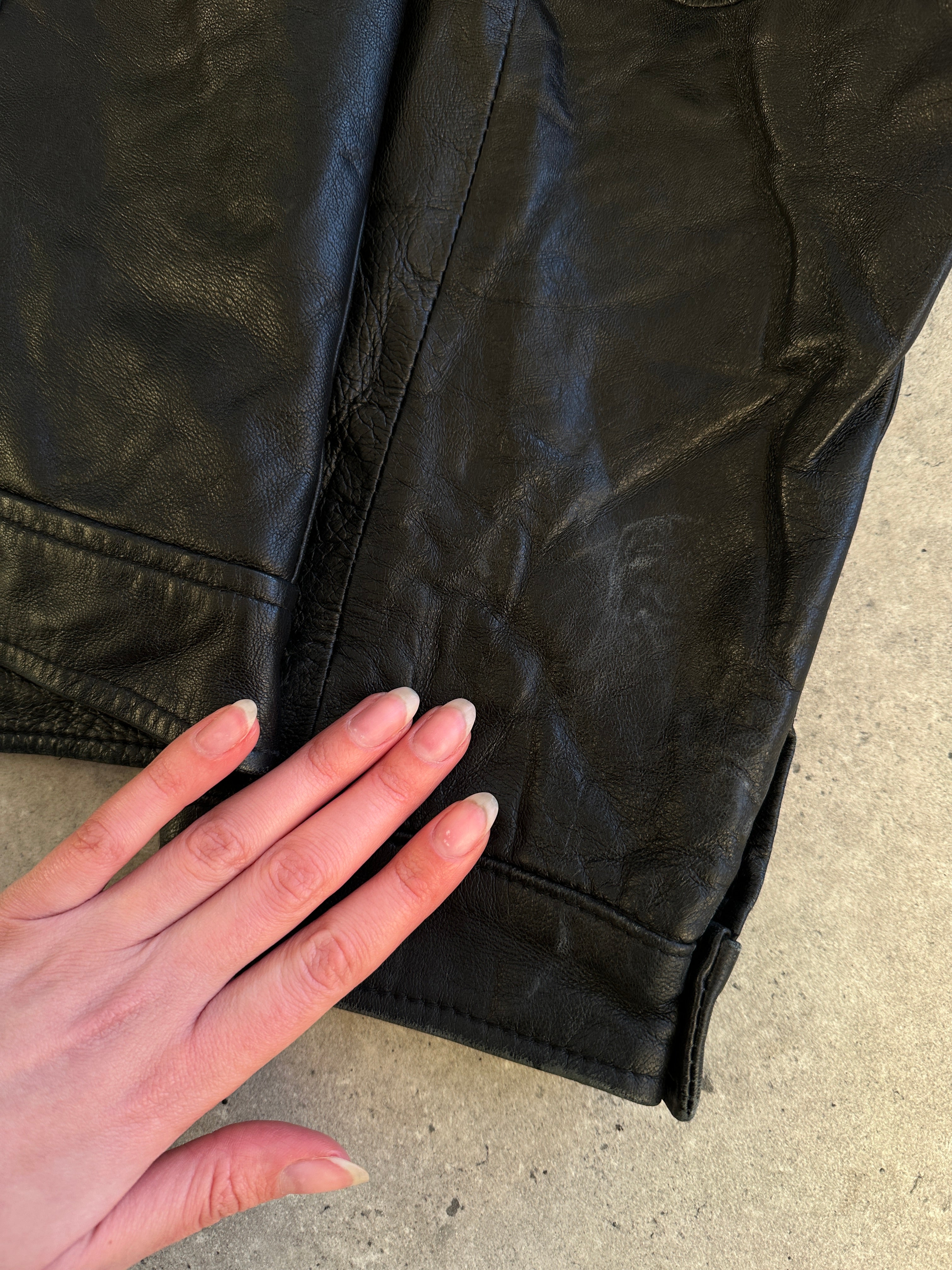 Vintage men's zip-up leather jacket with classic design, featuring a sleek leather exterior and front zipper closure.