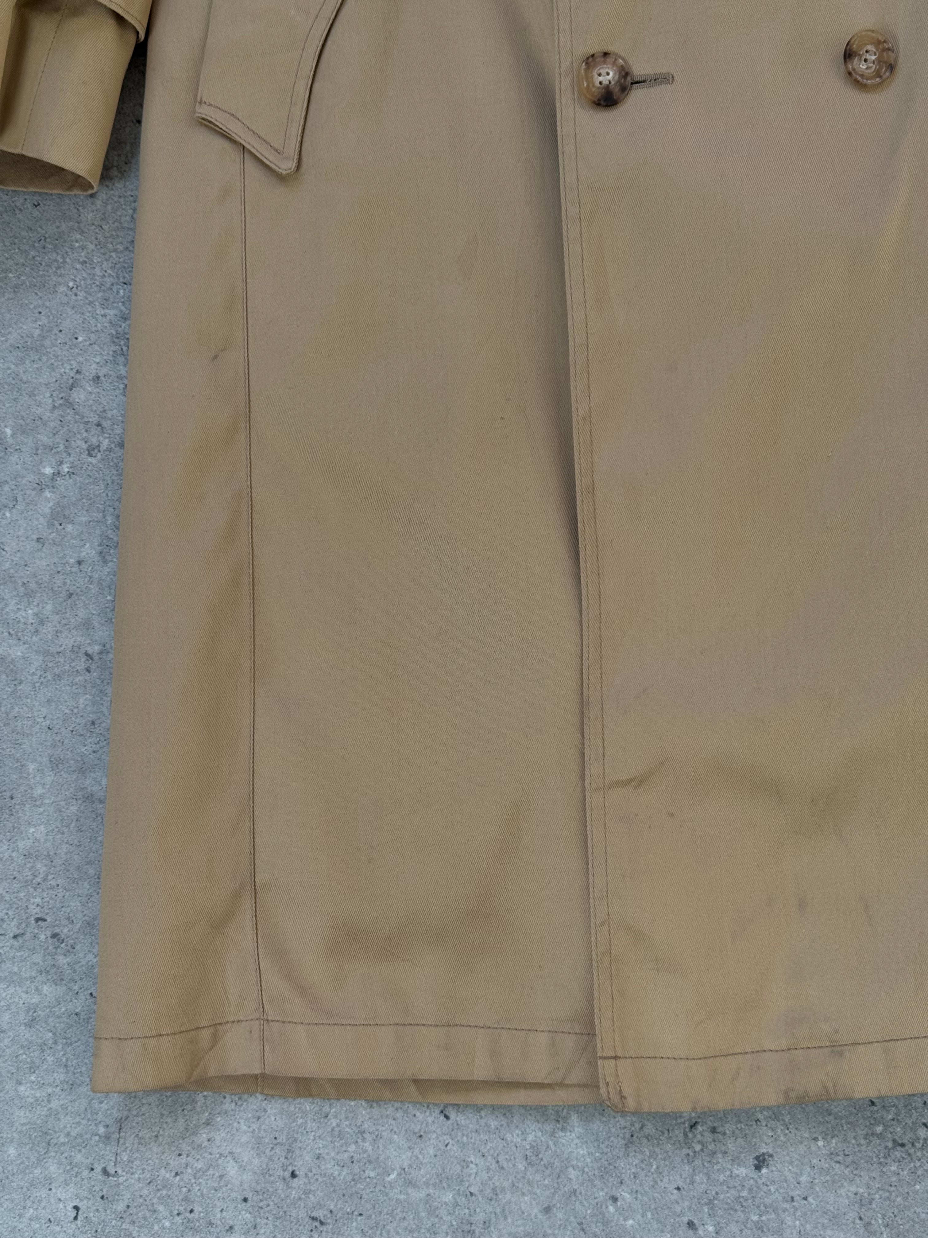 Christian Dior Paris 1980s cotton double-breasted trench coat, beige color, classic design, shown on a hanger.