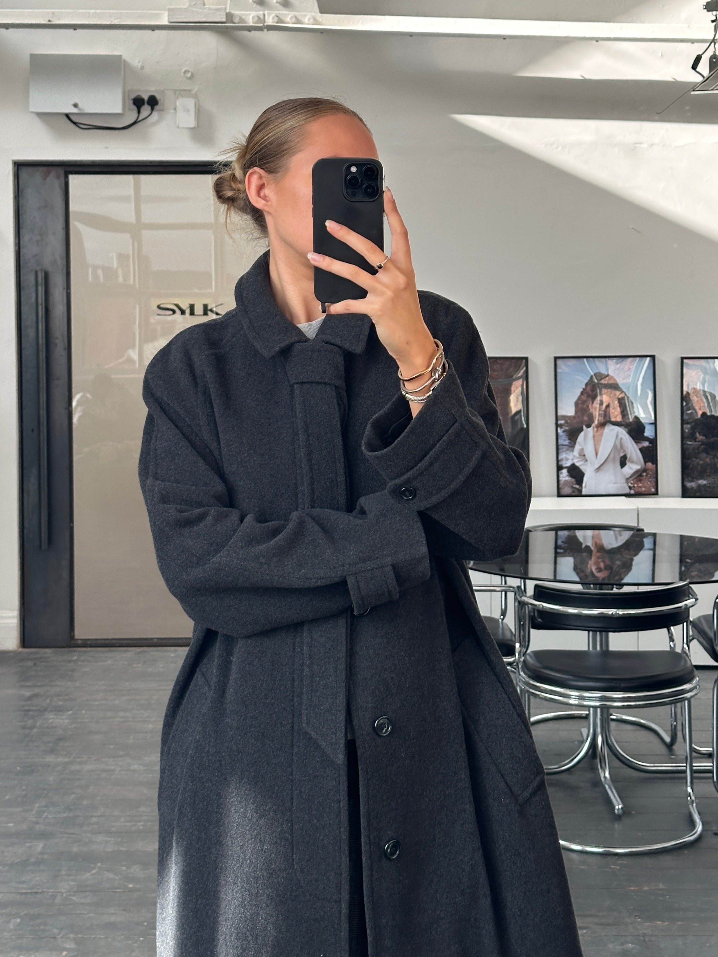 Vintage 1990s wool cashmere belted coat in size L/XL, featuring classic design and warm, textured fabric.