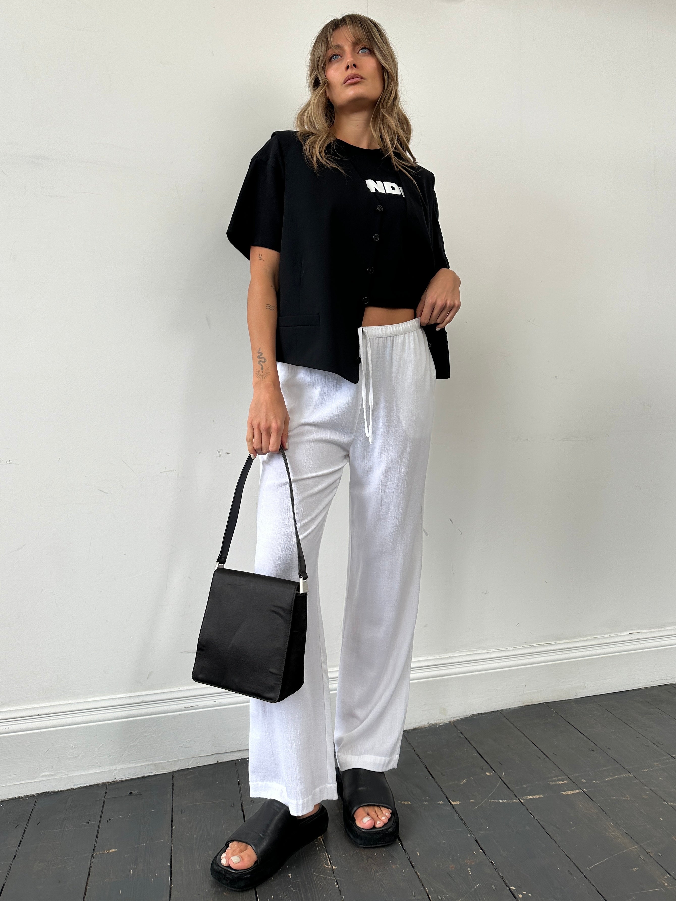 Vintage wide-leg pull-on trousers with elastic waistband and crinkle effect, available in waist sizes W28-32.
