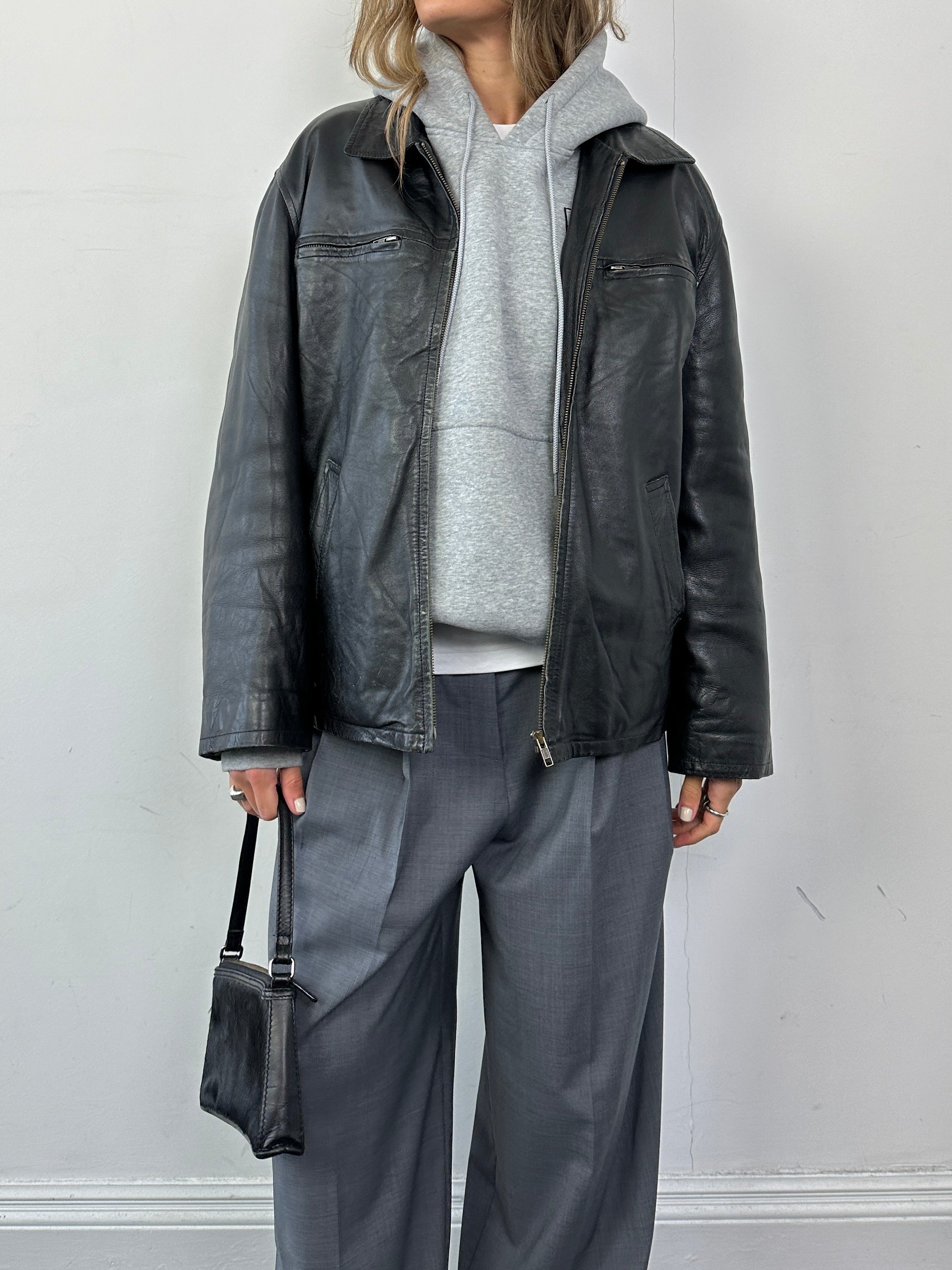 Conbipel zip-up leather jacket in size L, featuring a sleek design with a front zipper and classic leather finish.