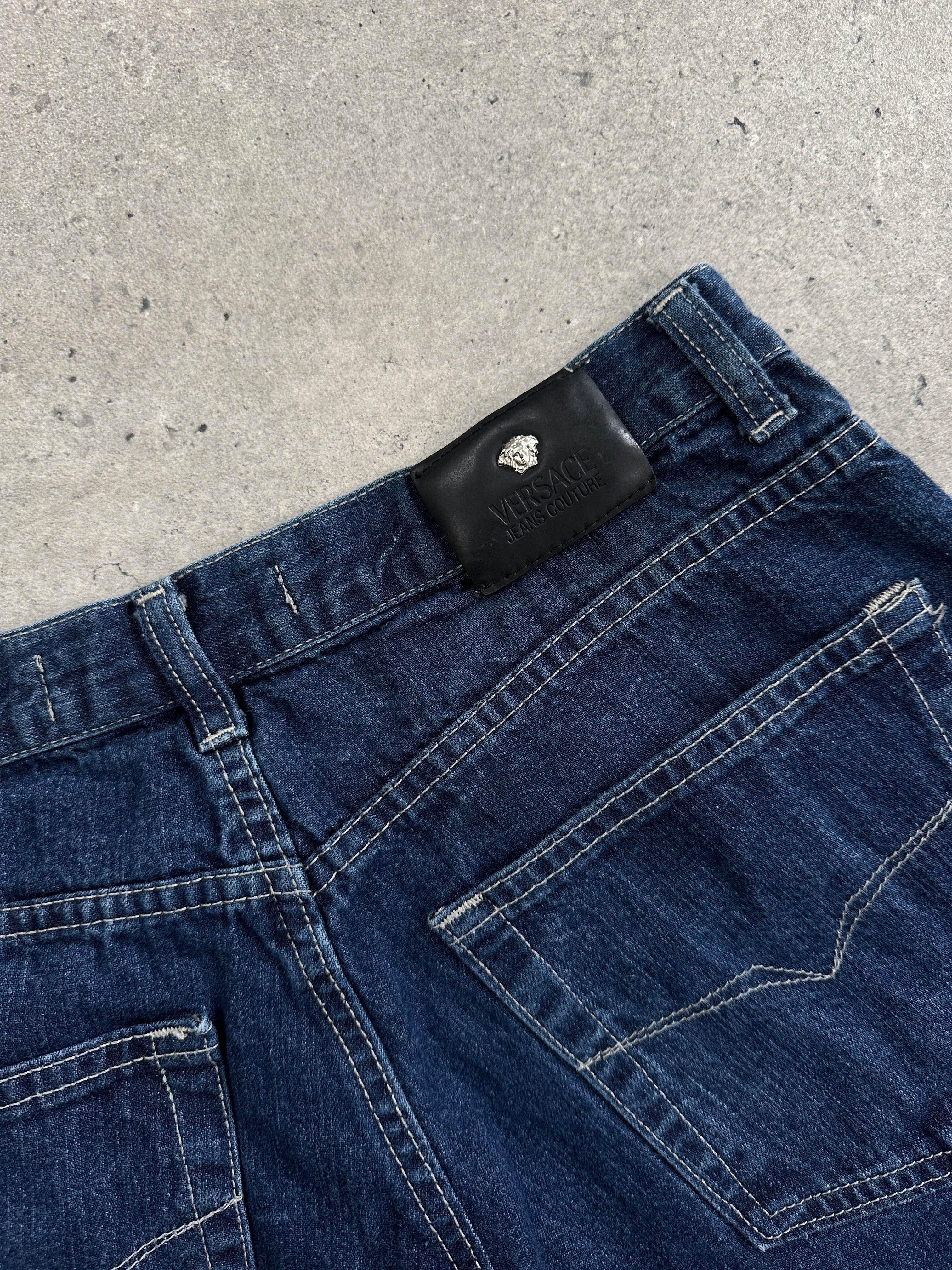 Versace Jeans Couture mid-wasted denim jeans in size W27, featuring classic blue denim and stylish fit.