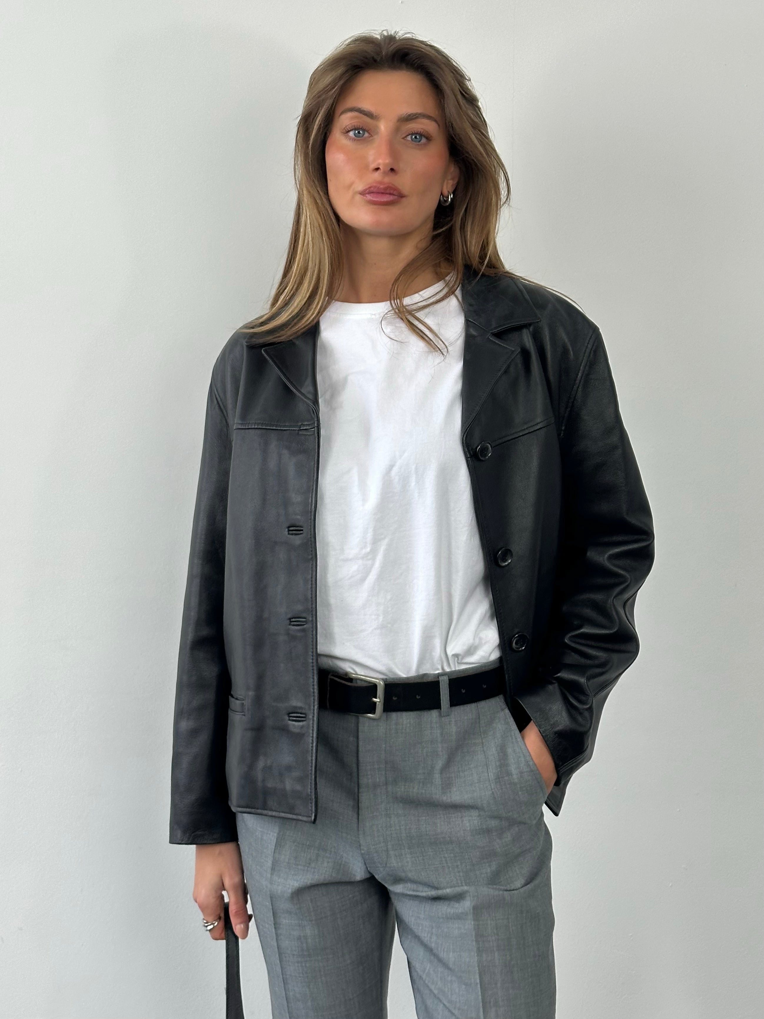 Vintage 1990s boxy leather jacket, size M, featuring classic design and textured leather, front view with collar and zip closure.