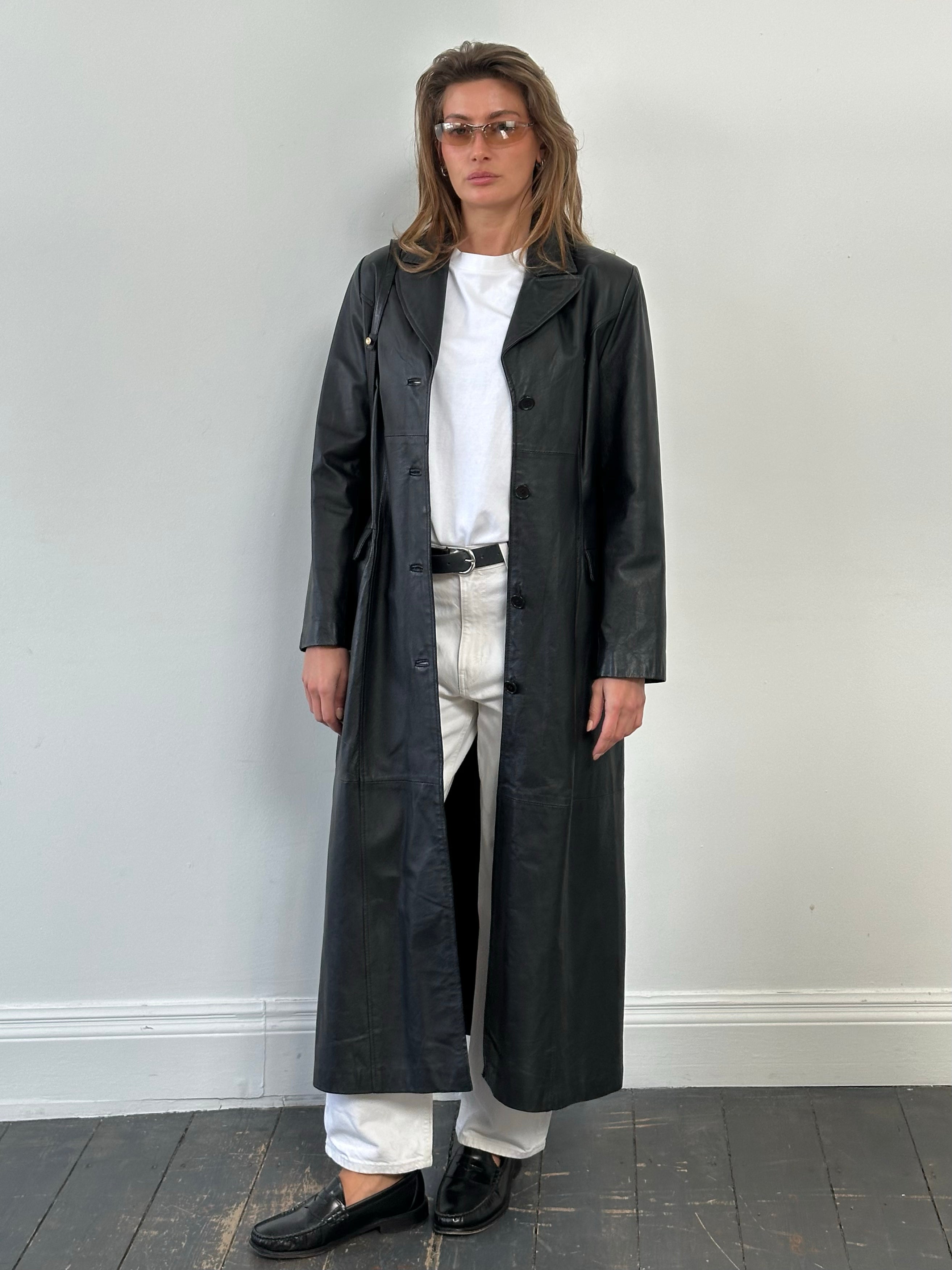 Vintage 1980s leather trench coat, floor-length style, in size M, featuring classic design and rich leather texture.