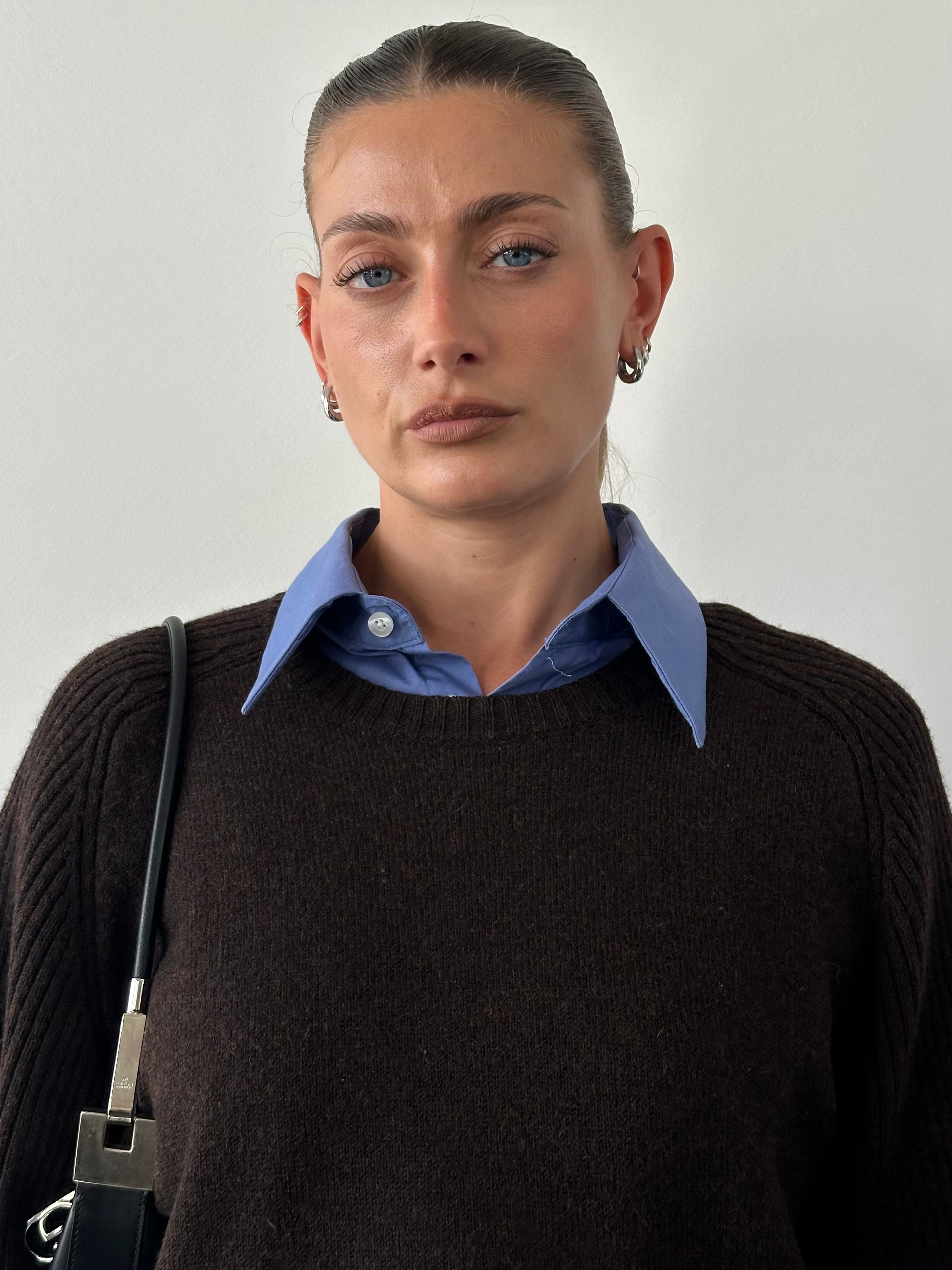 Jaeger Pure Merino Wool Jumper in size L/XL, navy blue, soft knit with round neckline and long sleeves, displayed on a hanger.