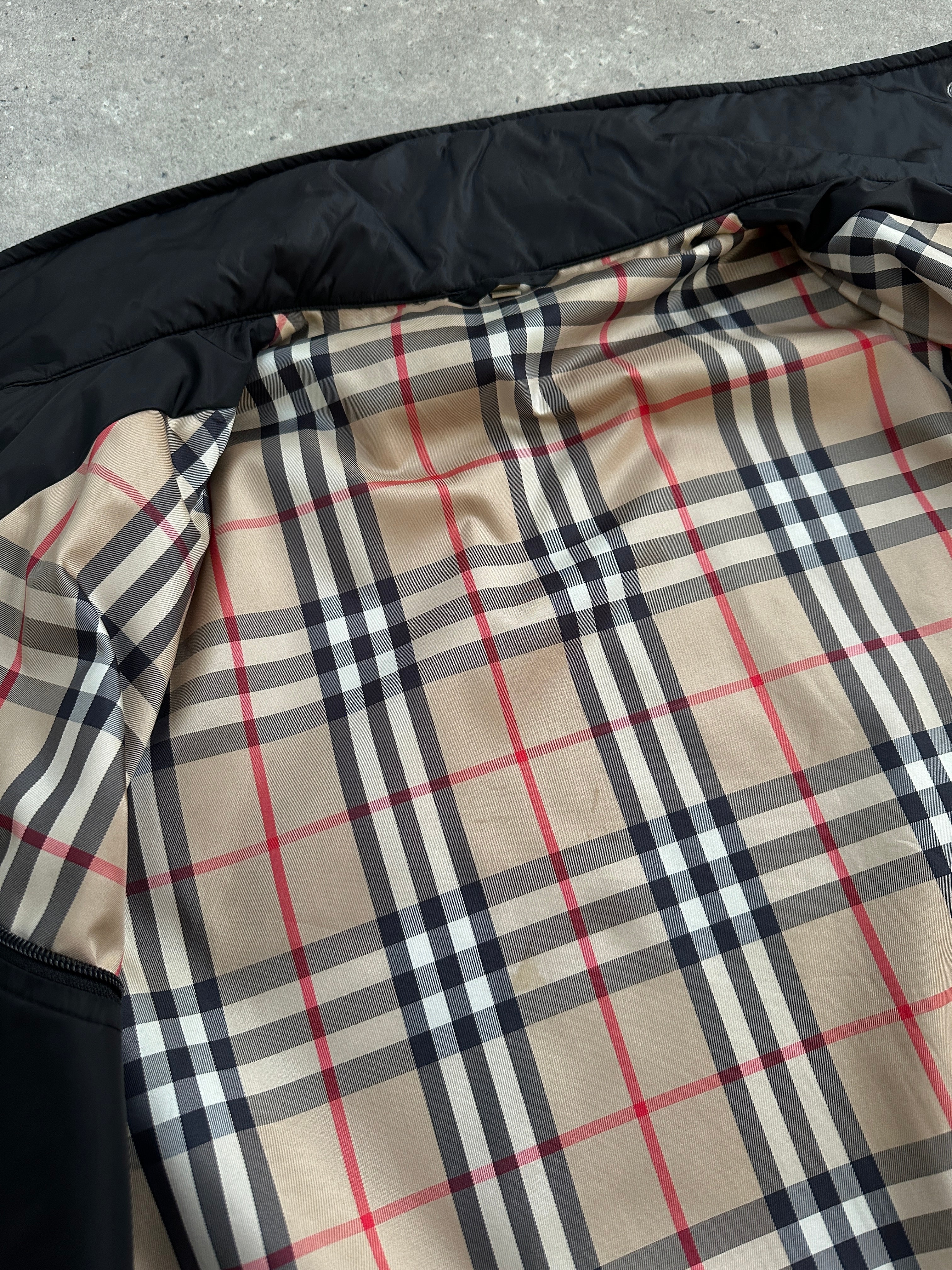 Burberry London 2000s nylon high neck jacket in black, front view showing sleek high collar and lightweight material.