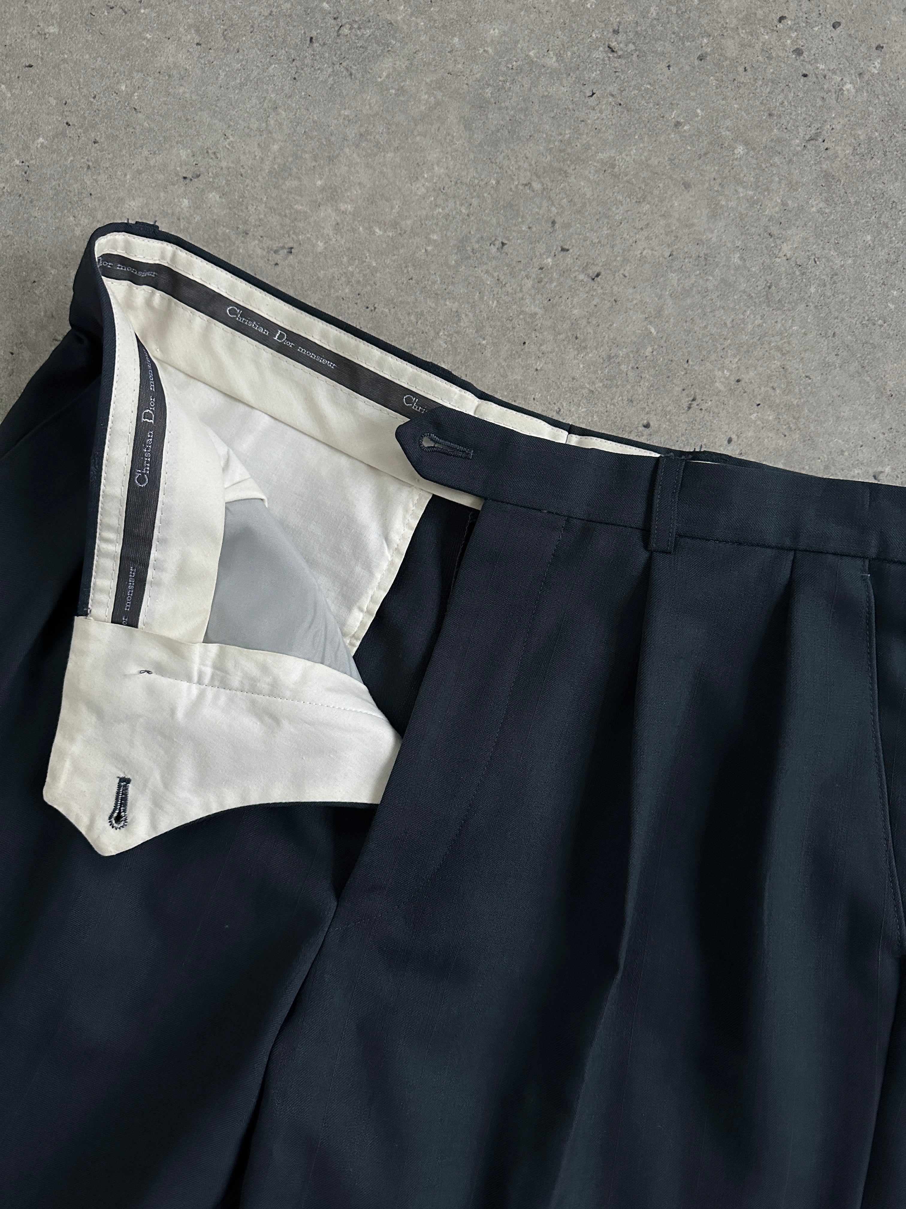 Christian Dior wool tapered leg tailored trousers in navy, featuring a classic fit and clean waistband, displayed on a plain background