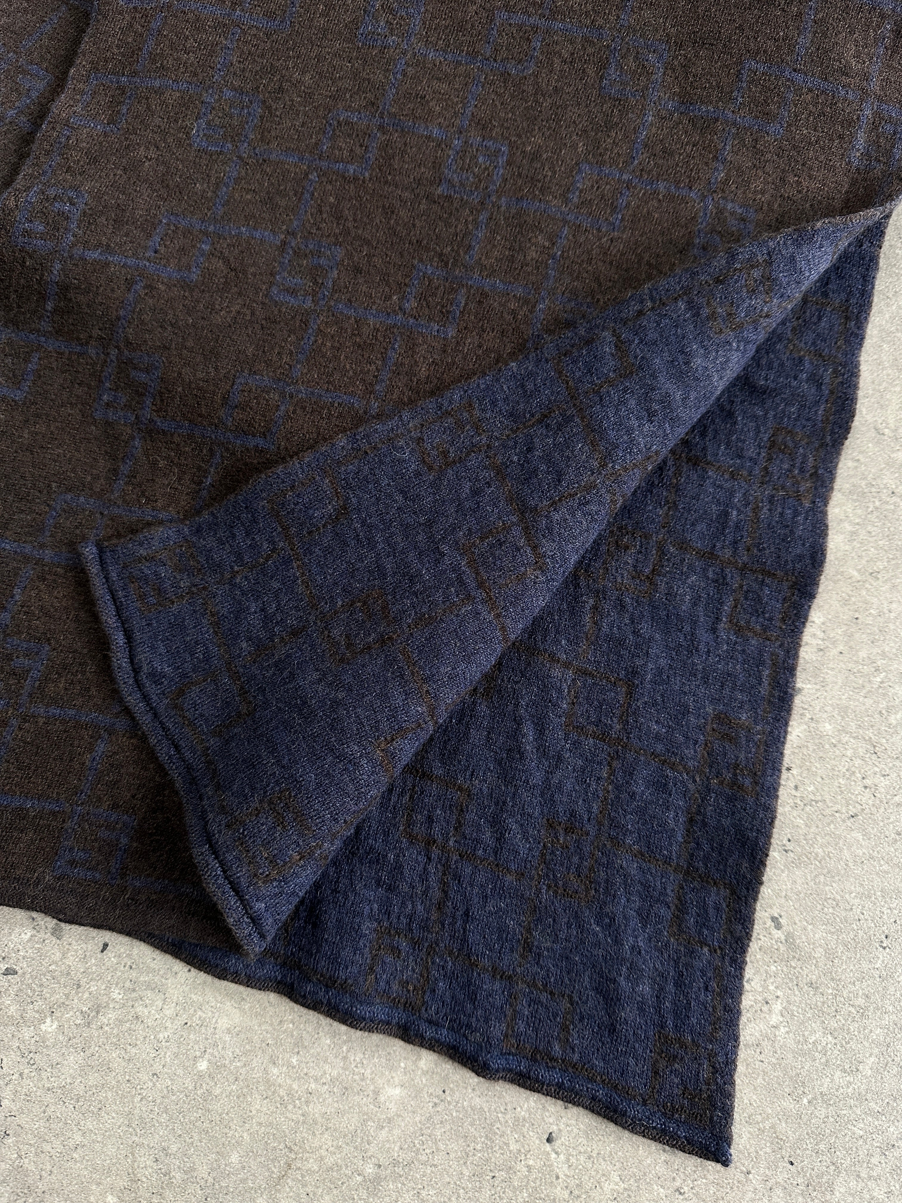 Fendi wool check scarf with classic pattern, soft texture, and fringed edges, stylish accessory for cold weather.