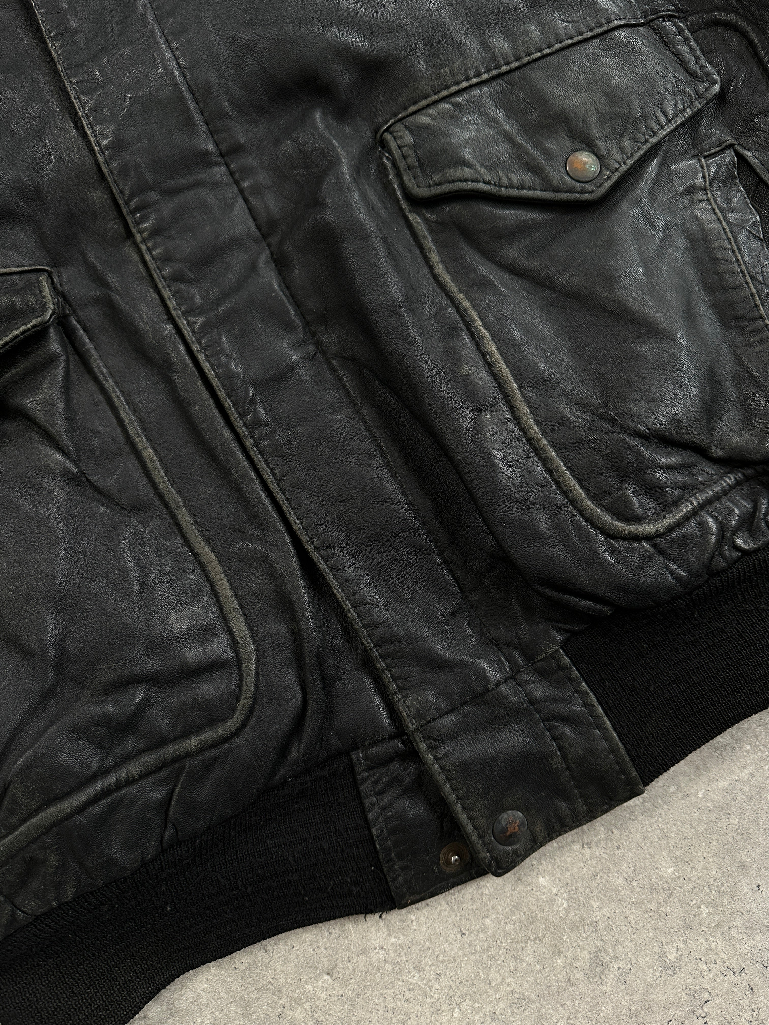 Vintage distressed leather bomber jacket in XL with a rugged, worn-in look, featuring classic design and metal zipper details.