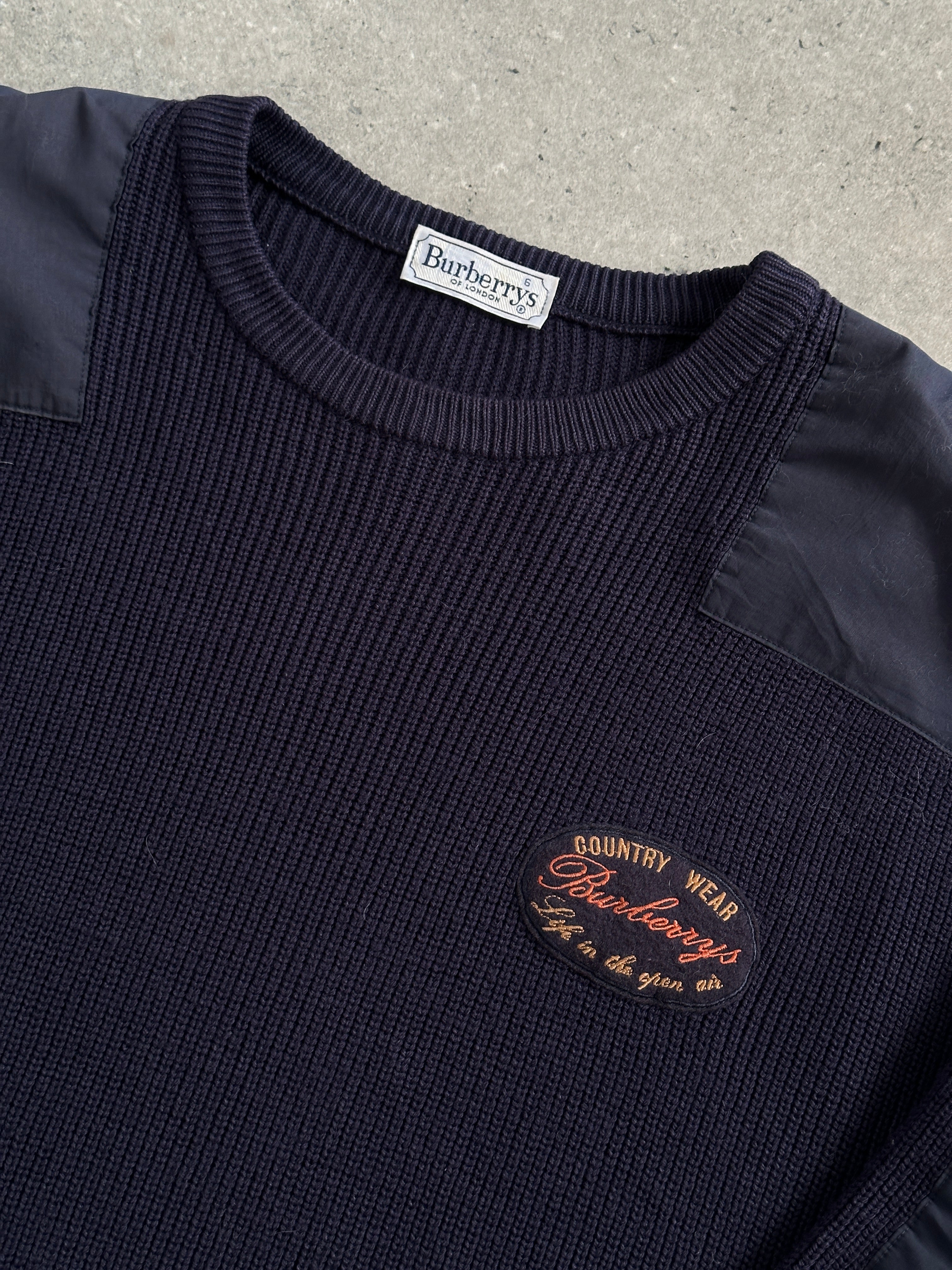 Burberry 1990s knitted chunky jumper with shoulder patch in XL, featuring classic design and textured knit fabric.