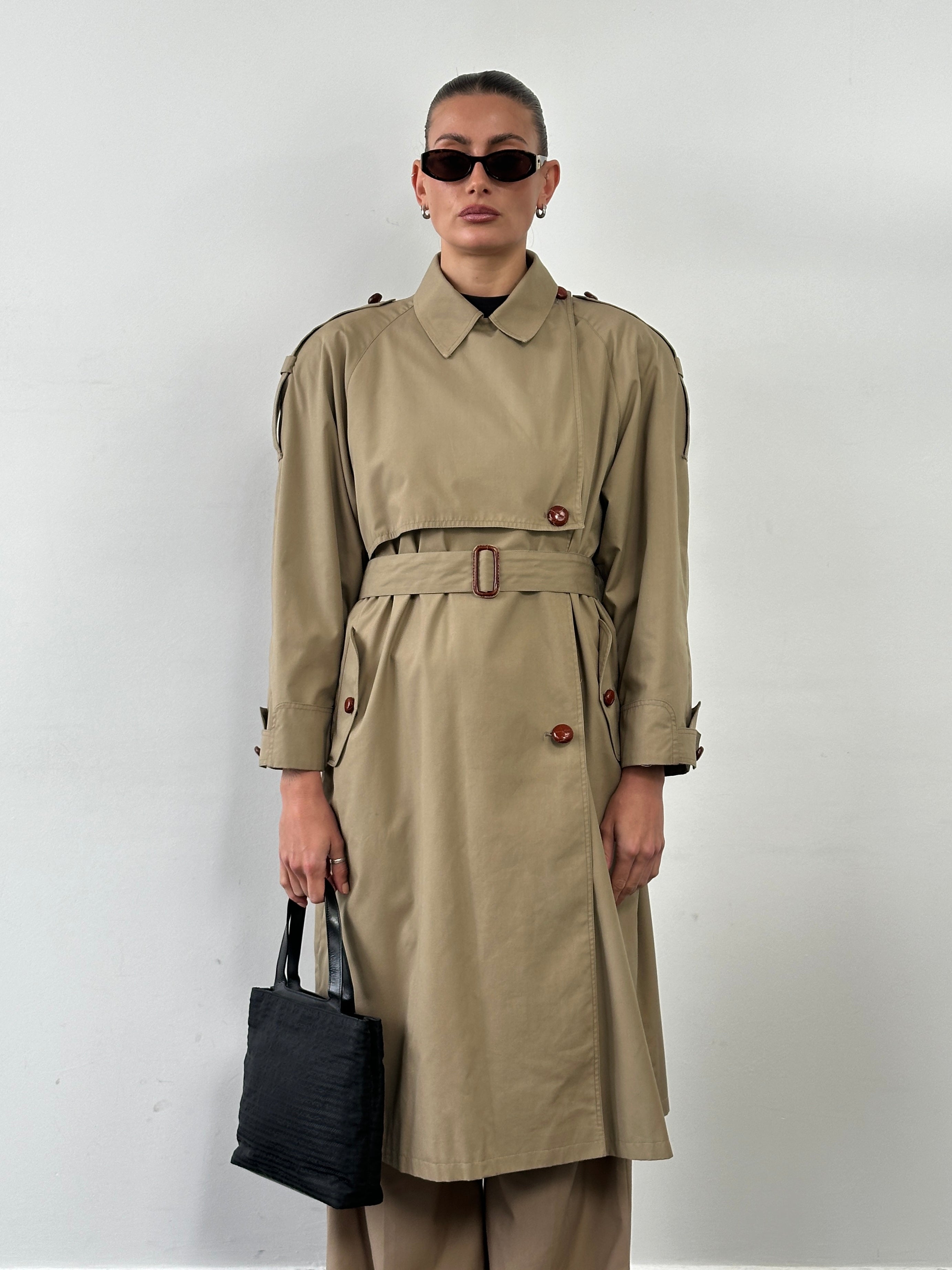 Vintage 1980s Nova Check trench coat with belt, tailored fit, classic style, in a neutral color, displayed on a hanger.