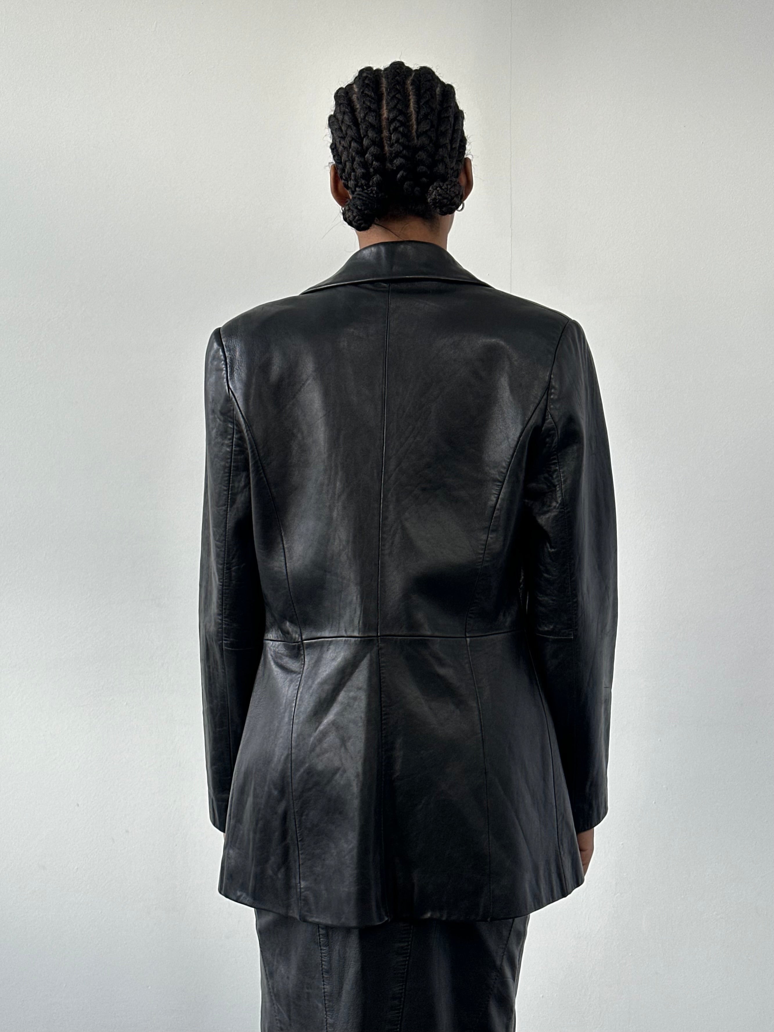Vintage 1990s fitted leather jacket with classic style, black leather, and a tailored fit, displayed on a mannequin.