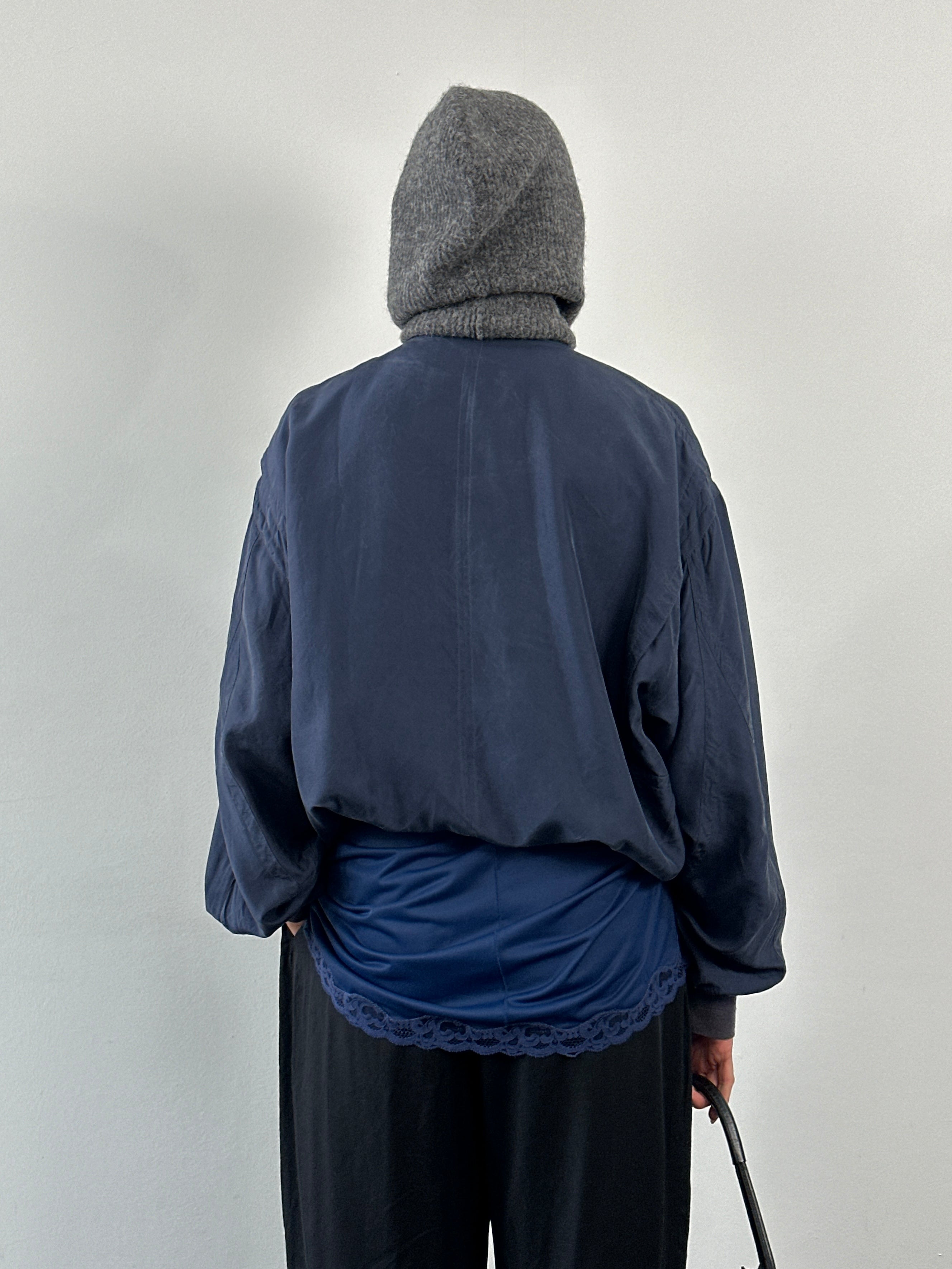 Vintage 1990s pure silk bomber jacket, size large, showcasing classic design and smooth fabric in a vintage style.