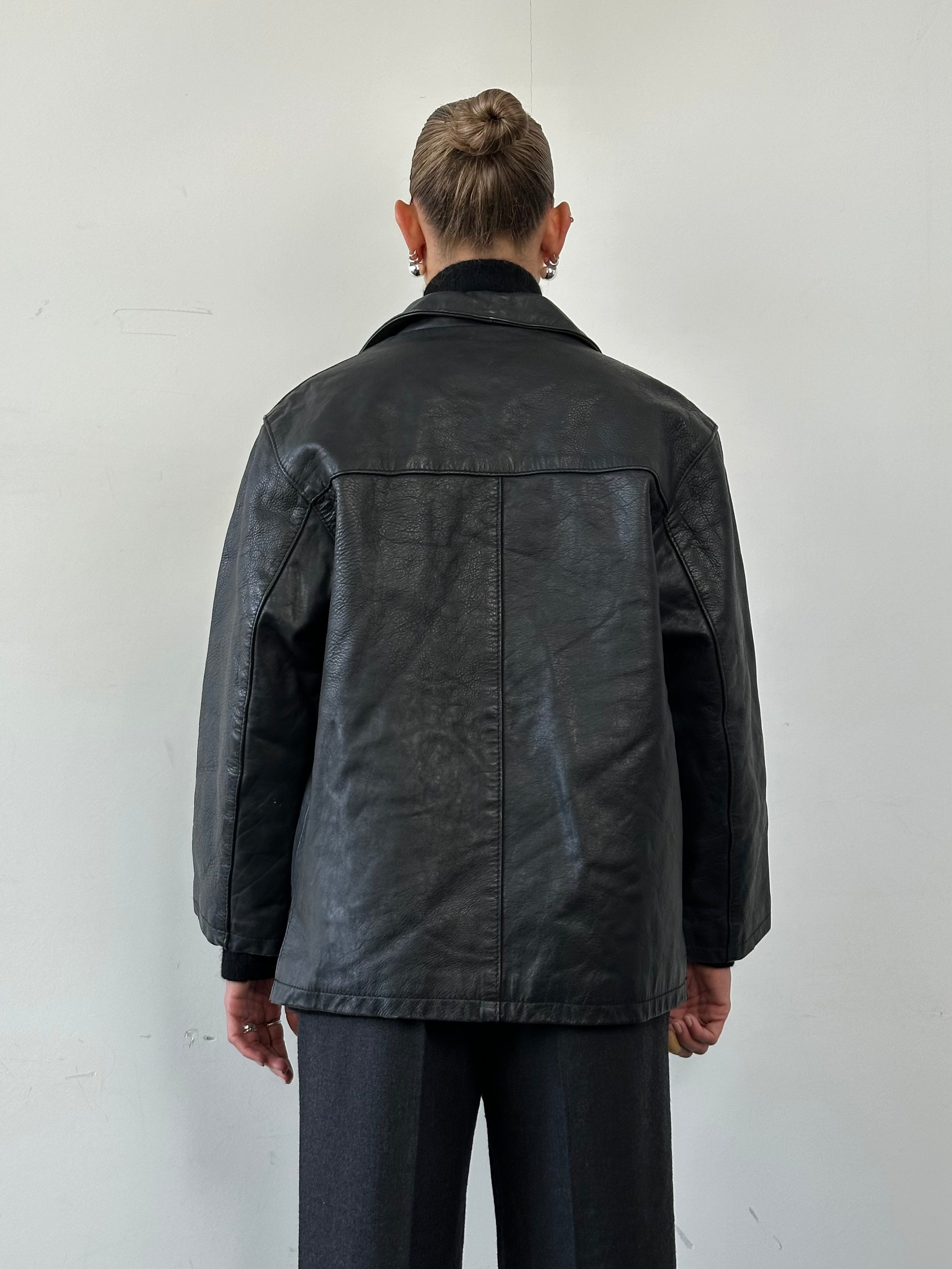 Vintage leather jacket in size M, showcasing classic design with distressed brown leather and detailed stitching.
