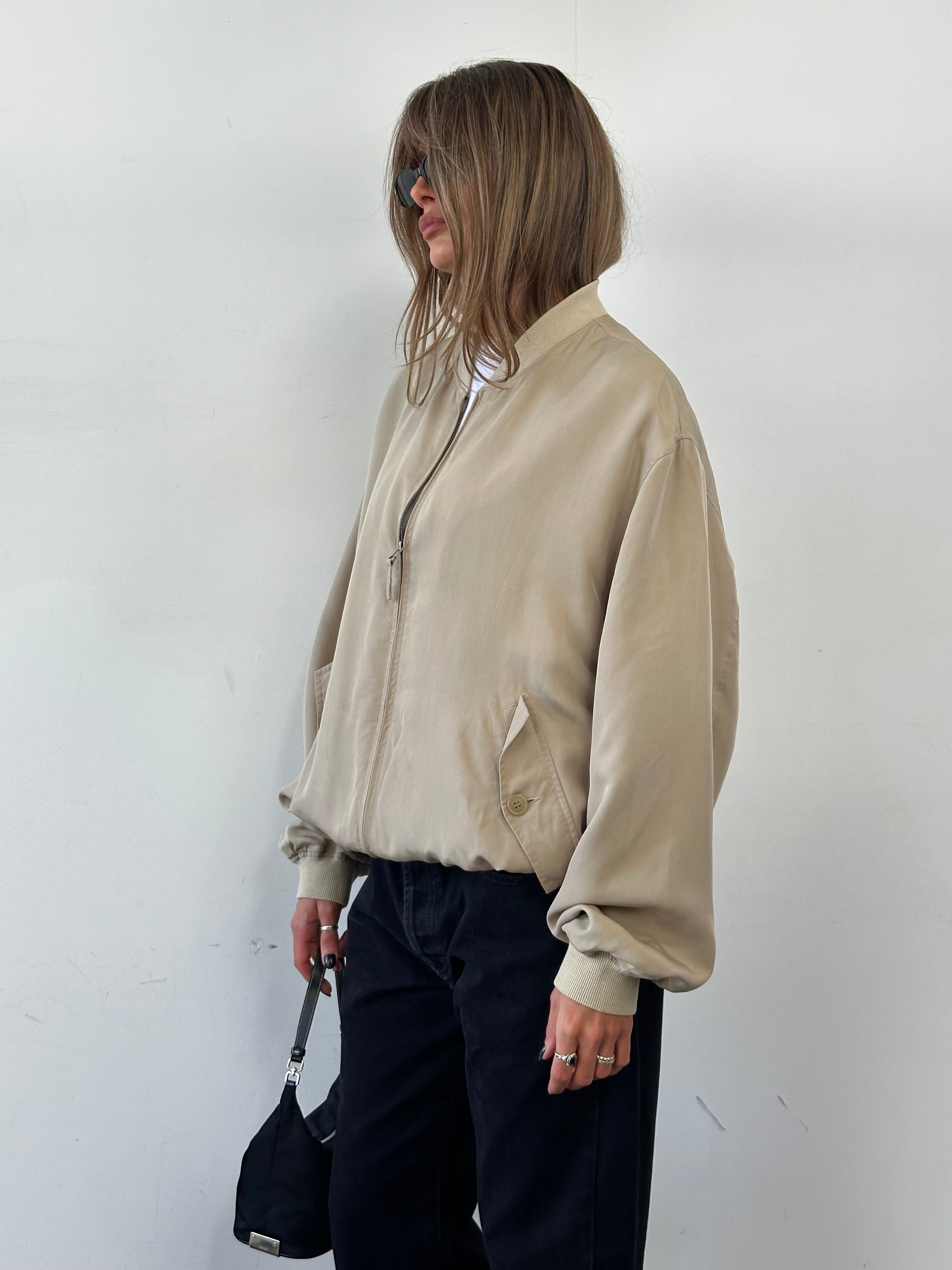 Vintage pure silk bomber jacket in XL size, featuring a classic design with a smooth, shiny silk fabric and ribbed collar.
