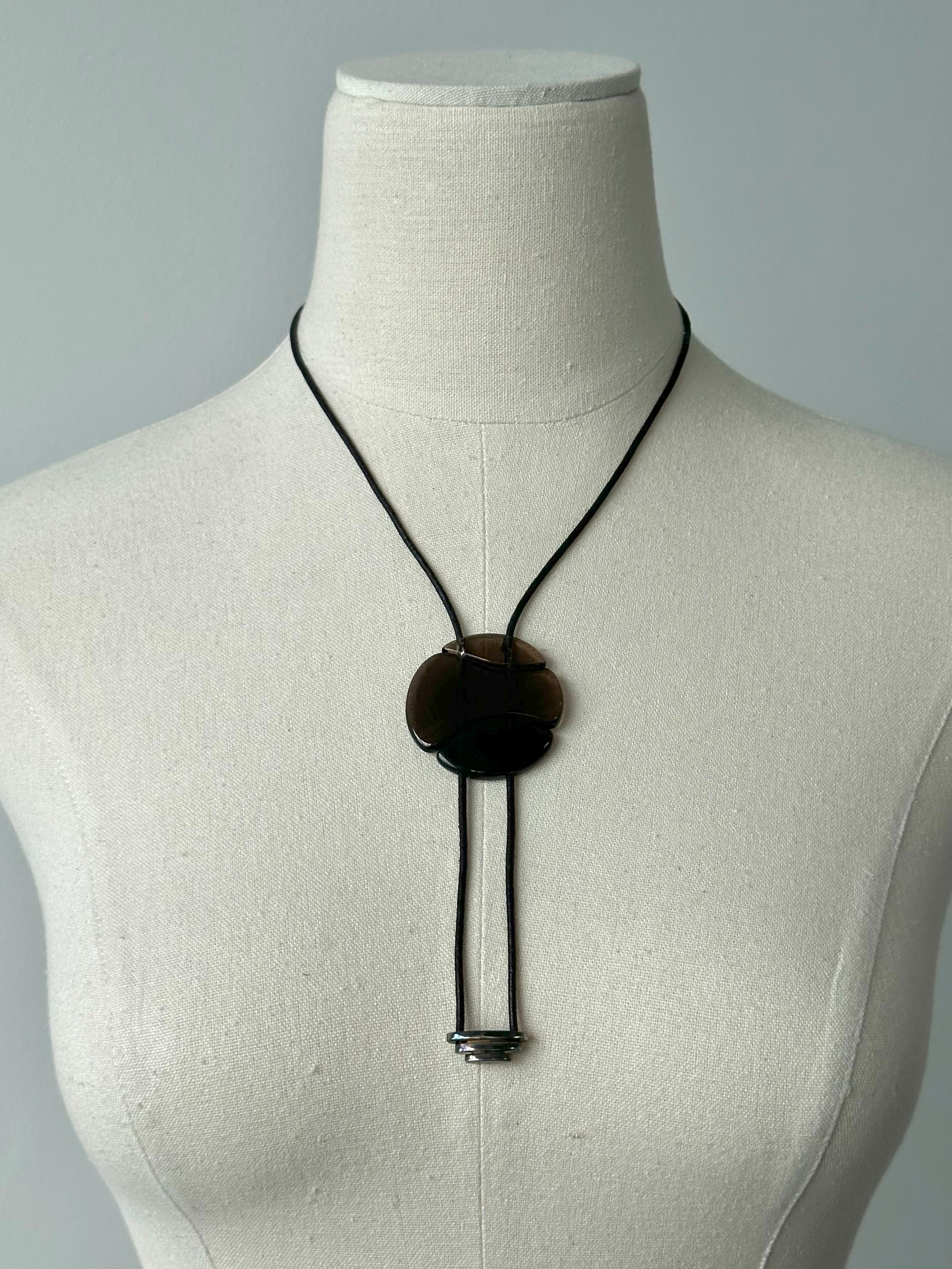 Emporio Armani 2000s glass pendant leather necklace featuring a sleek leather cord and a stylish glass pendant.