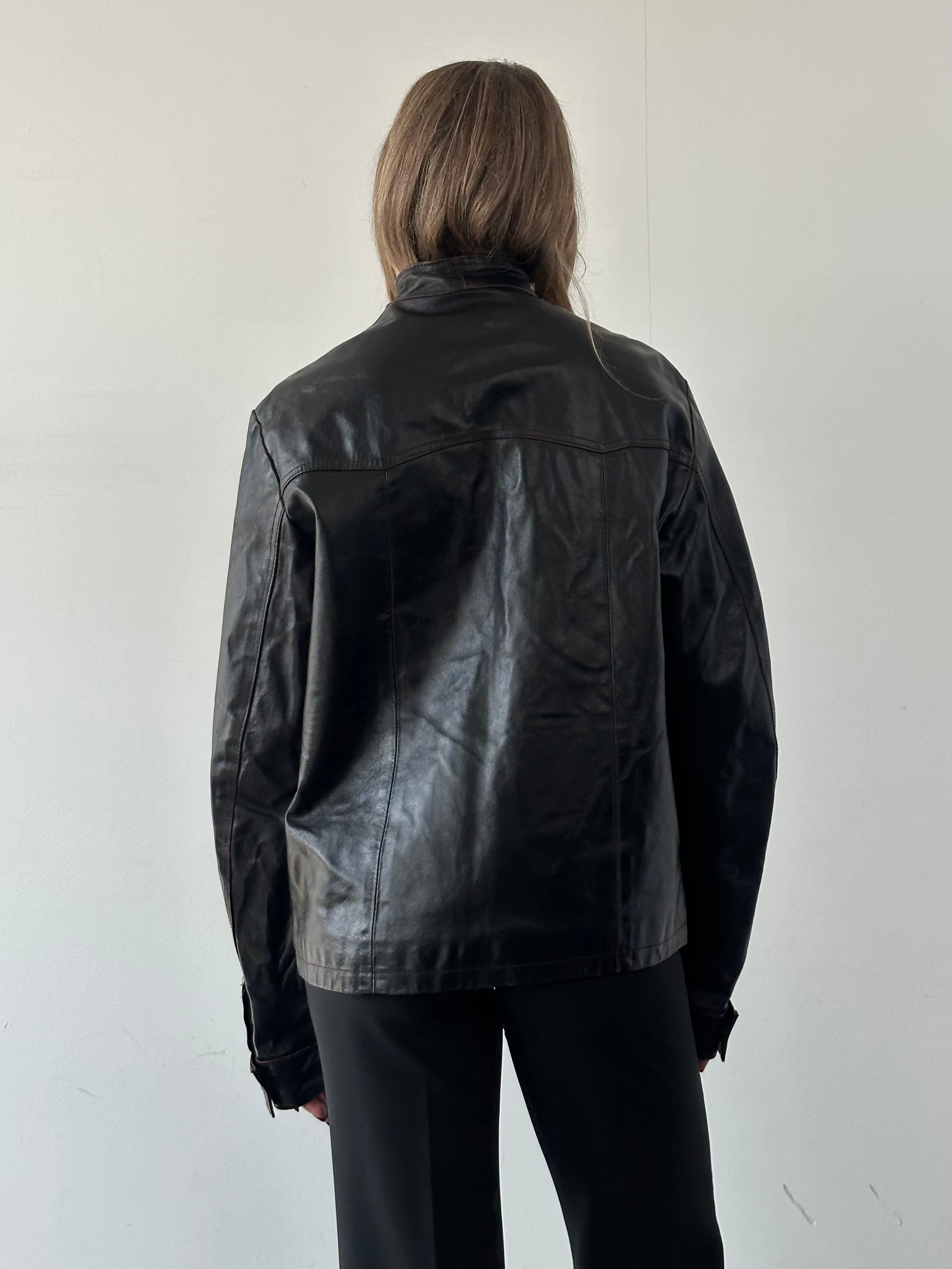 Vintage Italian distressed leather jacket with double zippers, in size L/XL, featuring a rugged, worn-in style.