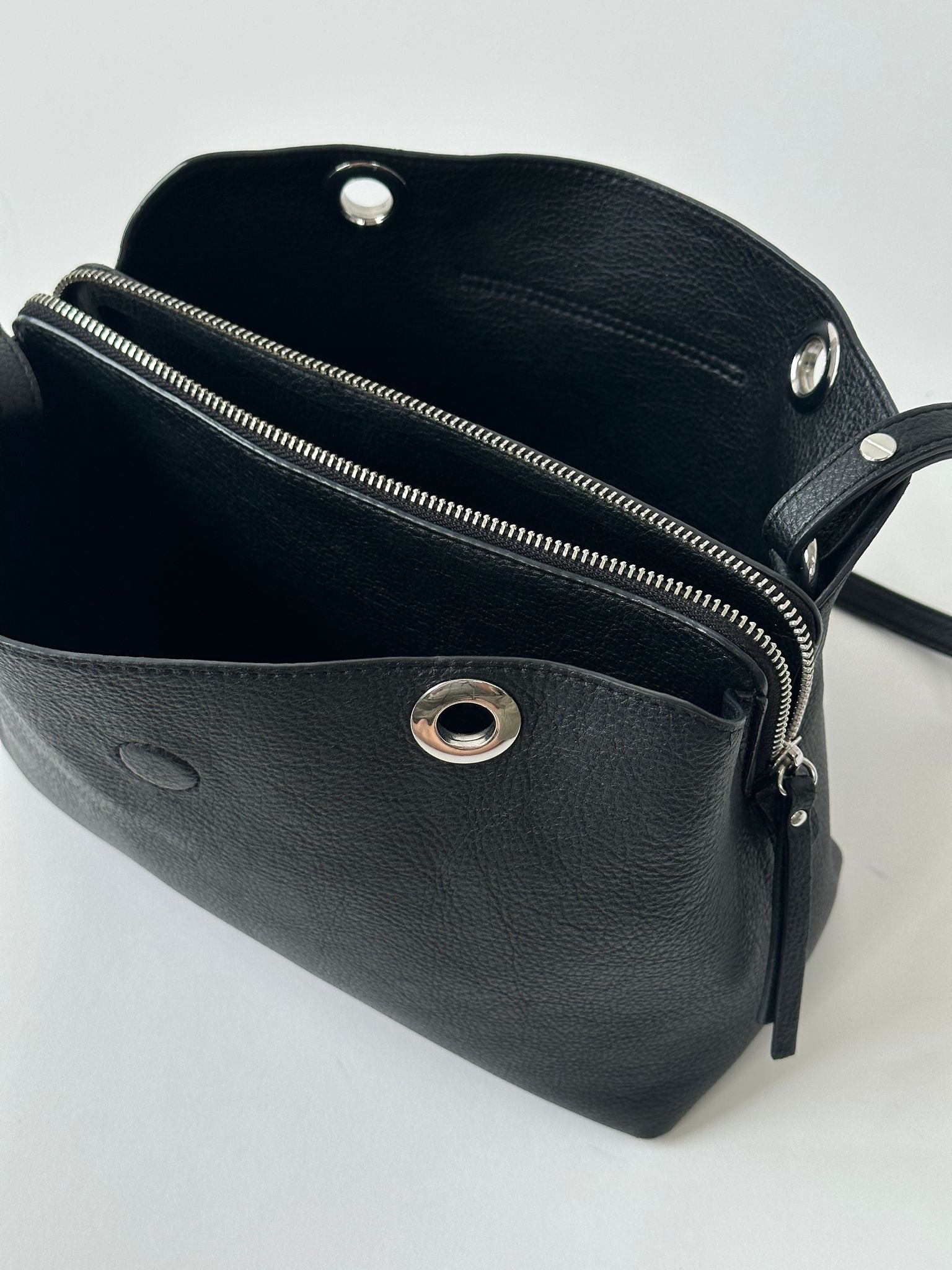Tommy Hilfiger crossbody bag with adjustable strap, navy blue fabric, and signature logo detailing.