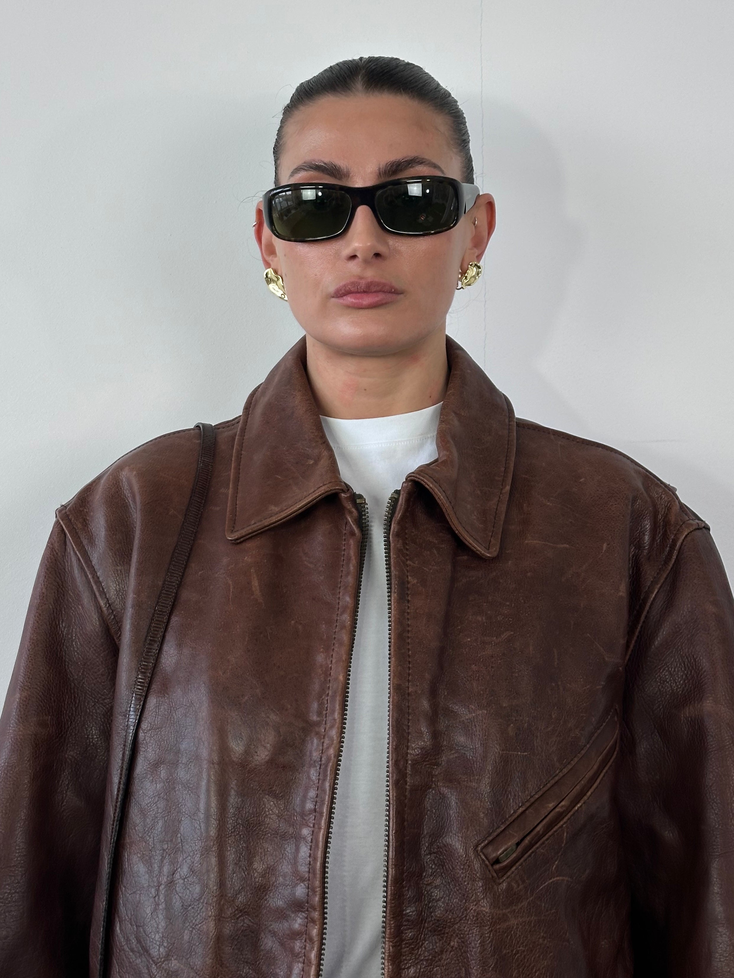 Vintage heavyweight leather jacket in XL size, featuring aged distressed leather and classic design, displayed on a neutral background.