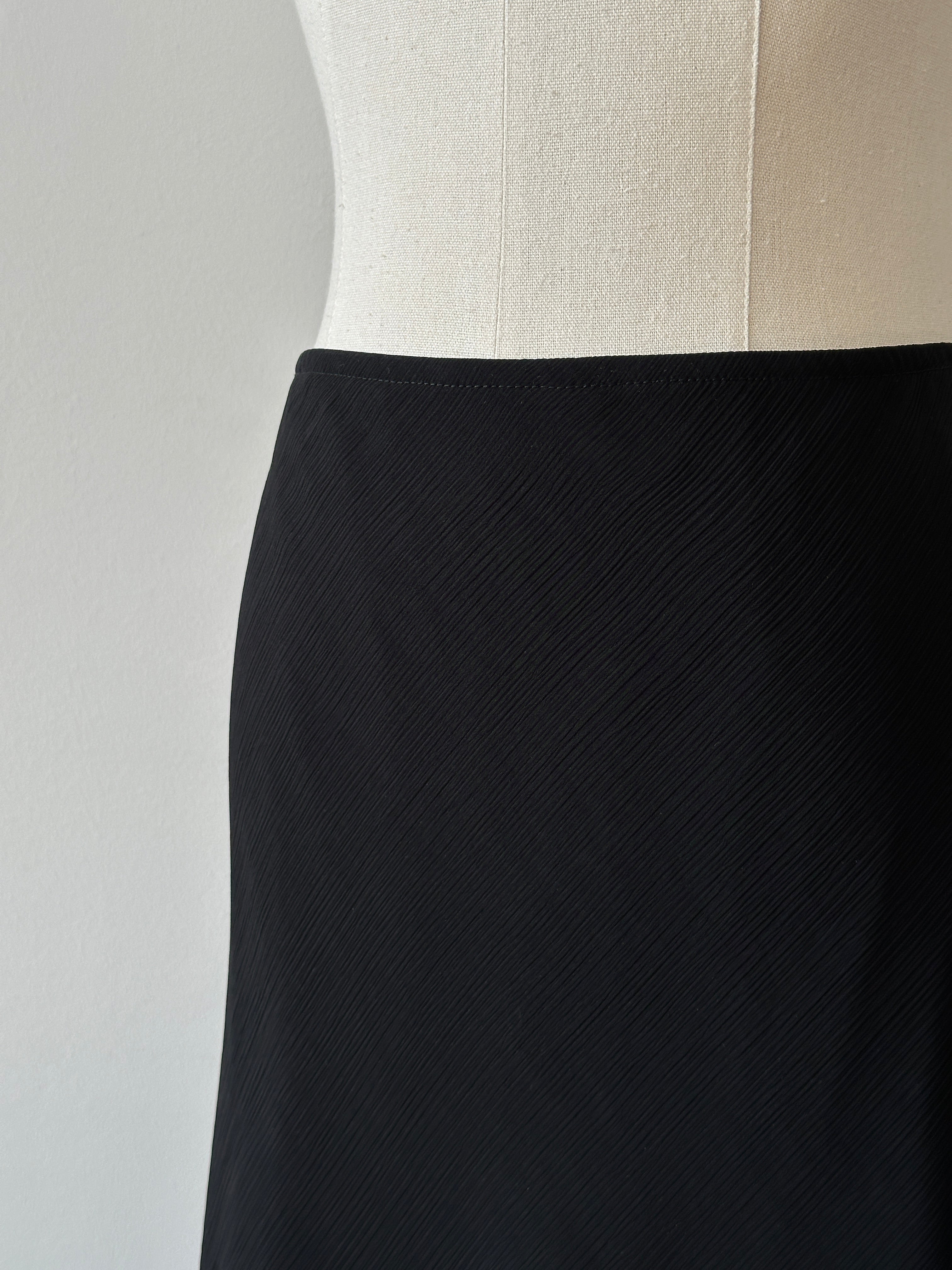 Vintage USA 1990s asymmetric midi skirt in denim with a high waist and vintage style, worn as a fashionable retro skirt.