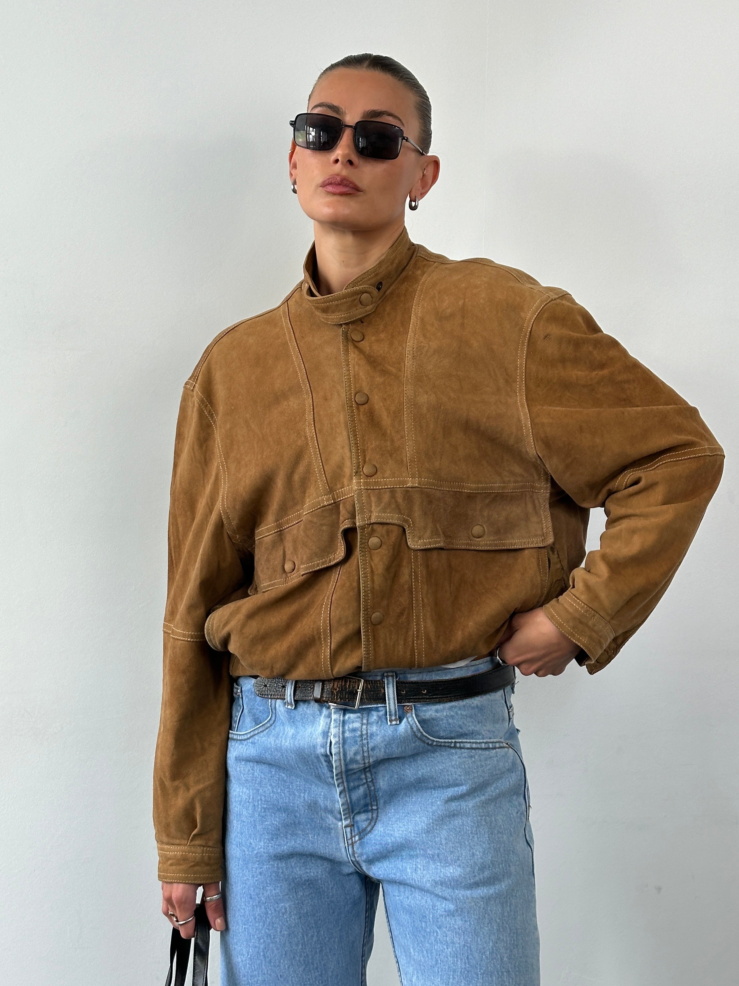 Vintage high neck suede bomber jacket in size M, shown in a close-up image highlighting the collar and textured suede fabric.
